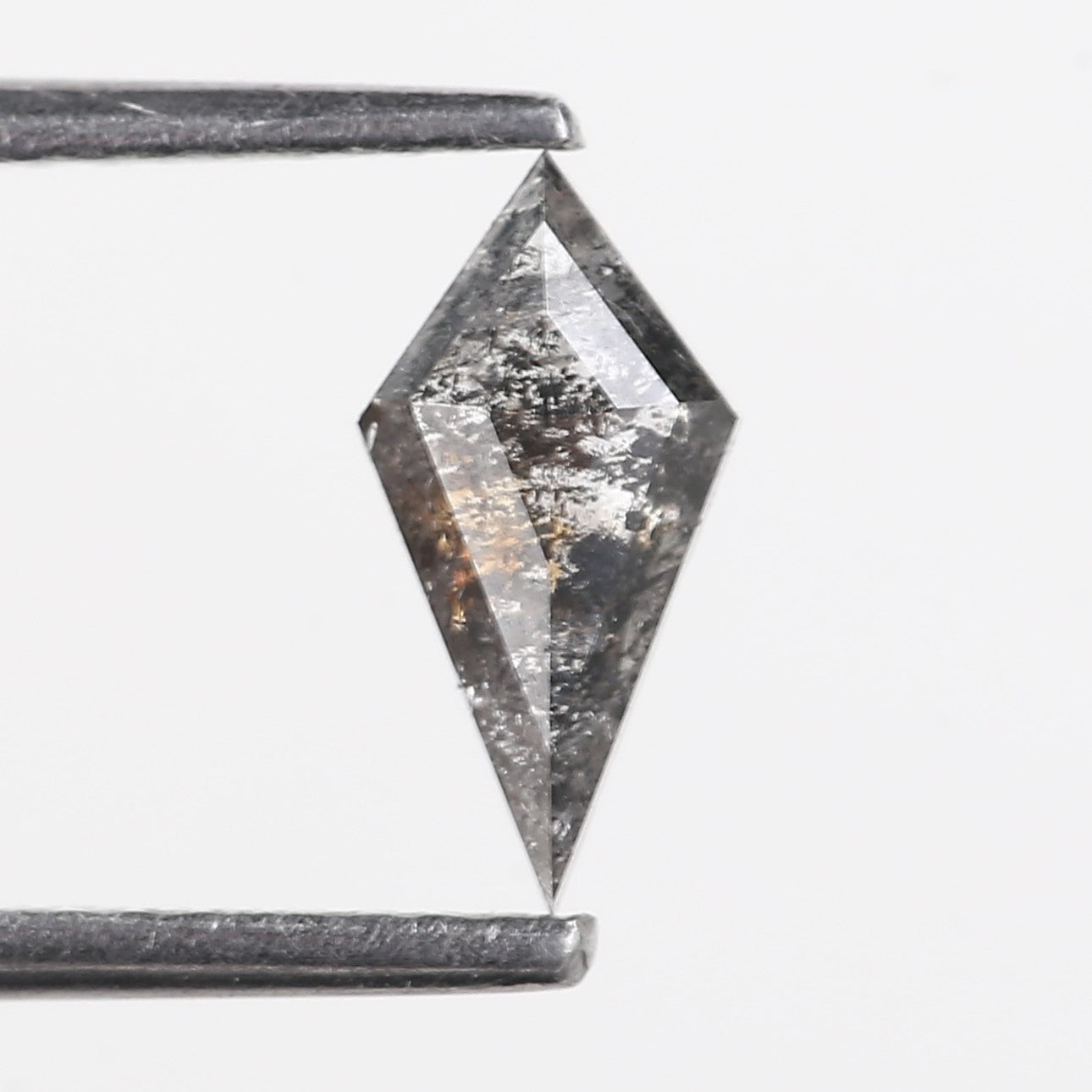 Faceted crystal pendant on a thin rod against a white background