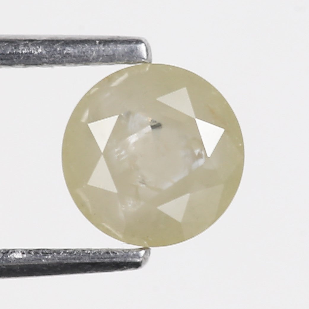 Round cut gemstone held between tweezers on a white background