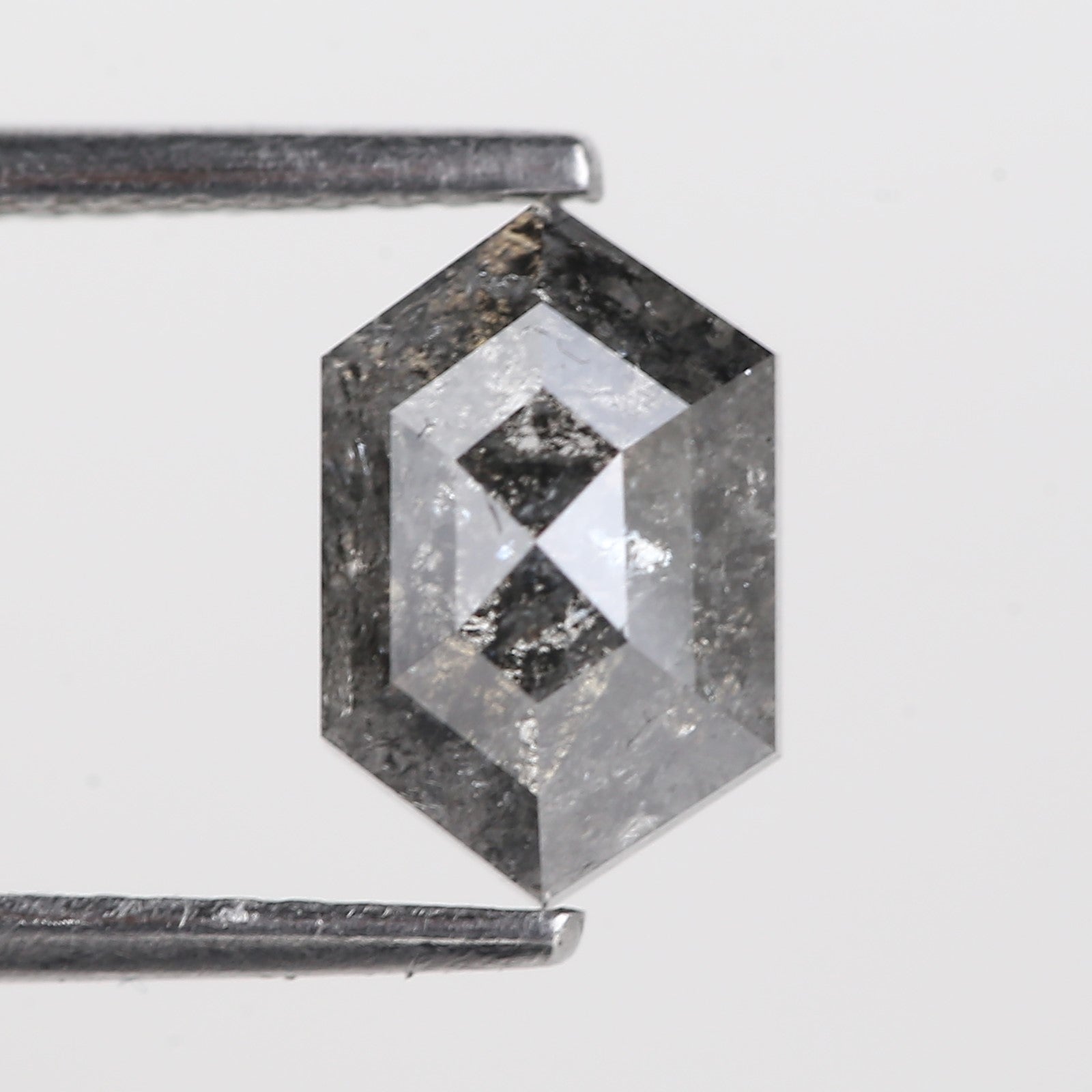 Hexagonal crystal with a white center on a light gray background