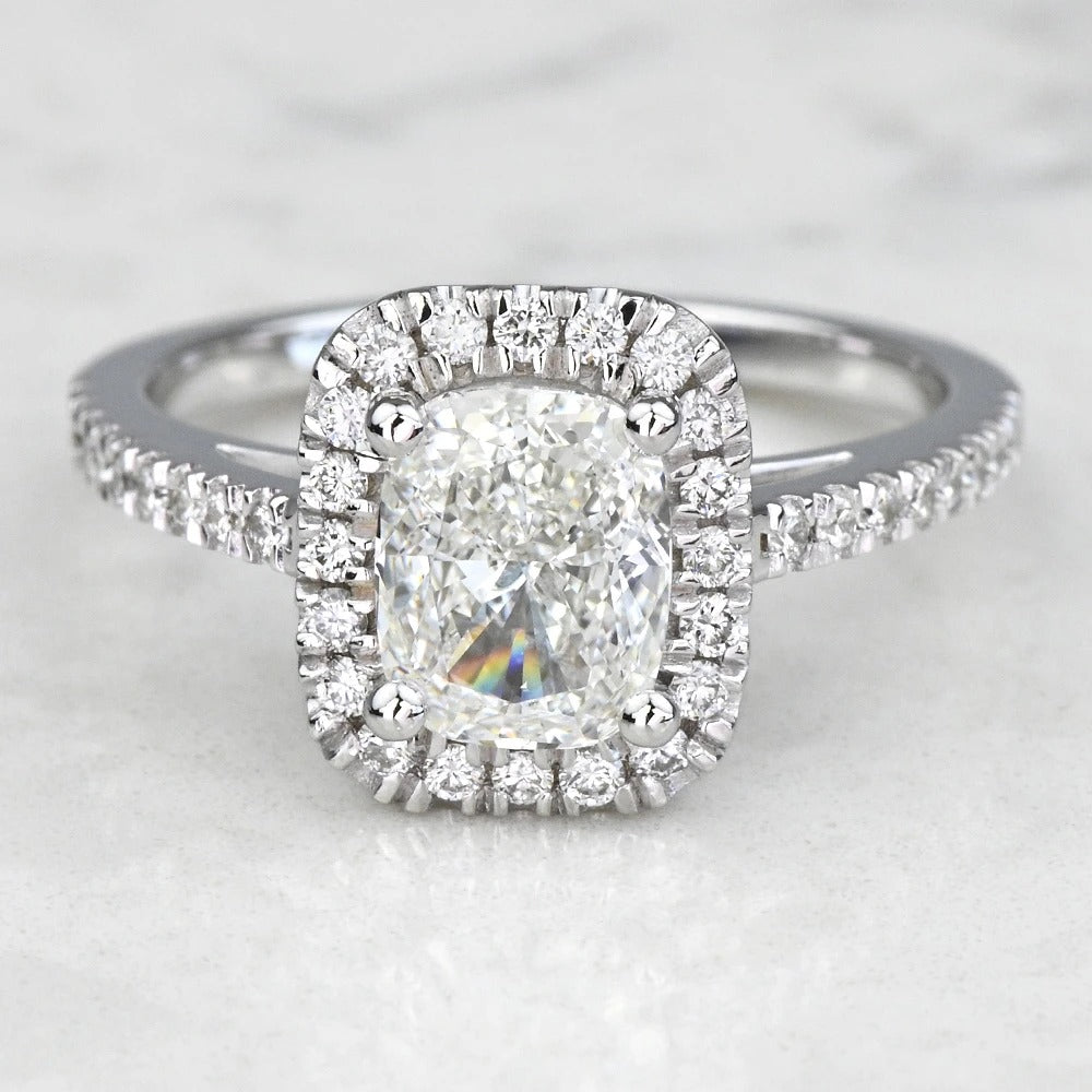 Diamond ring with a halo on a light background