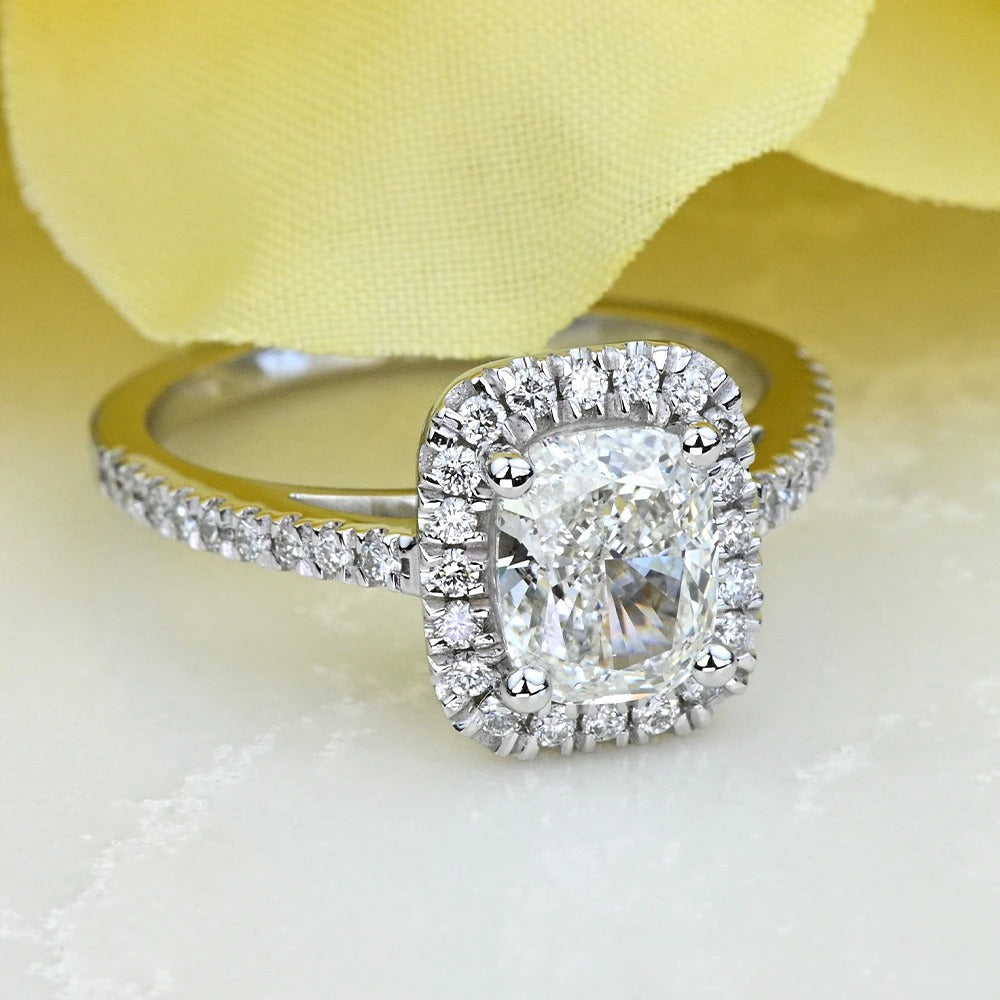 Diamond ring with a yellow flower in the background