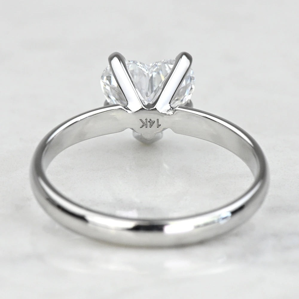 white gold with a heart-shaped diamond on a light gray background