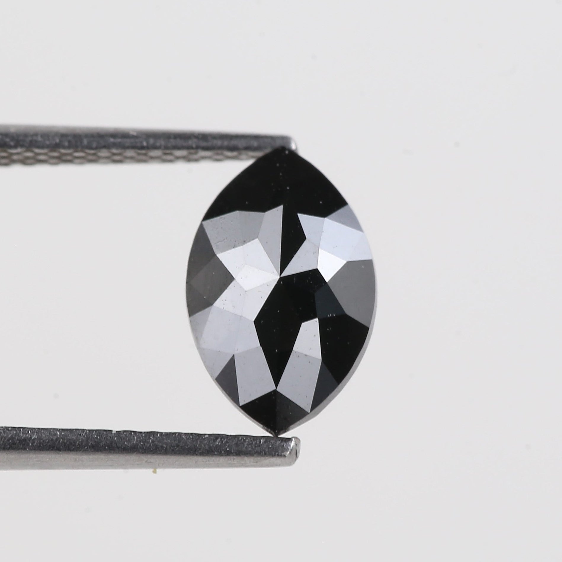 Faceted black gemstone on a white background
