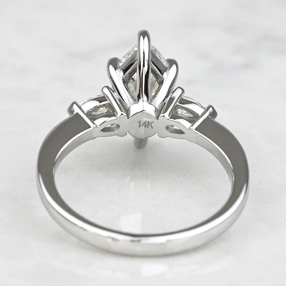 white gold ring with a diamond on a light gray background