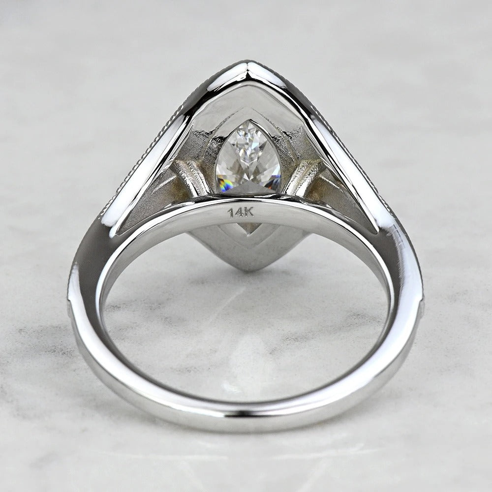 Silver ring with a diamond on a marble surface