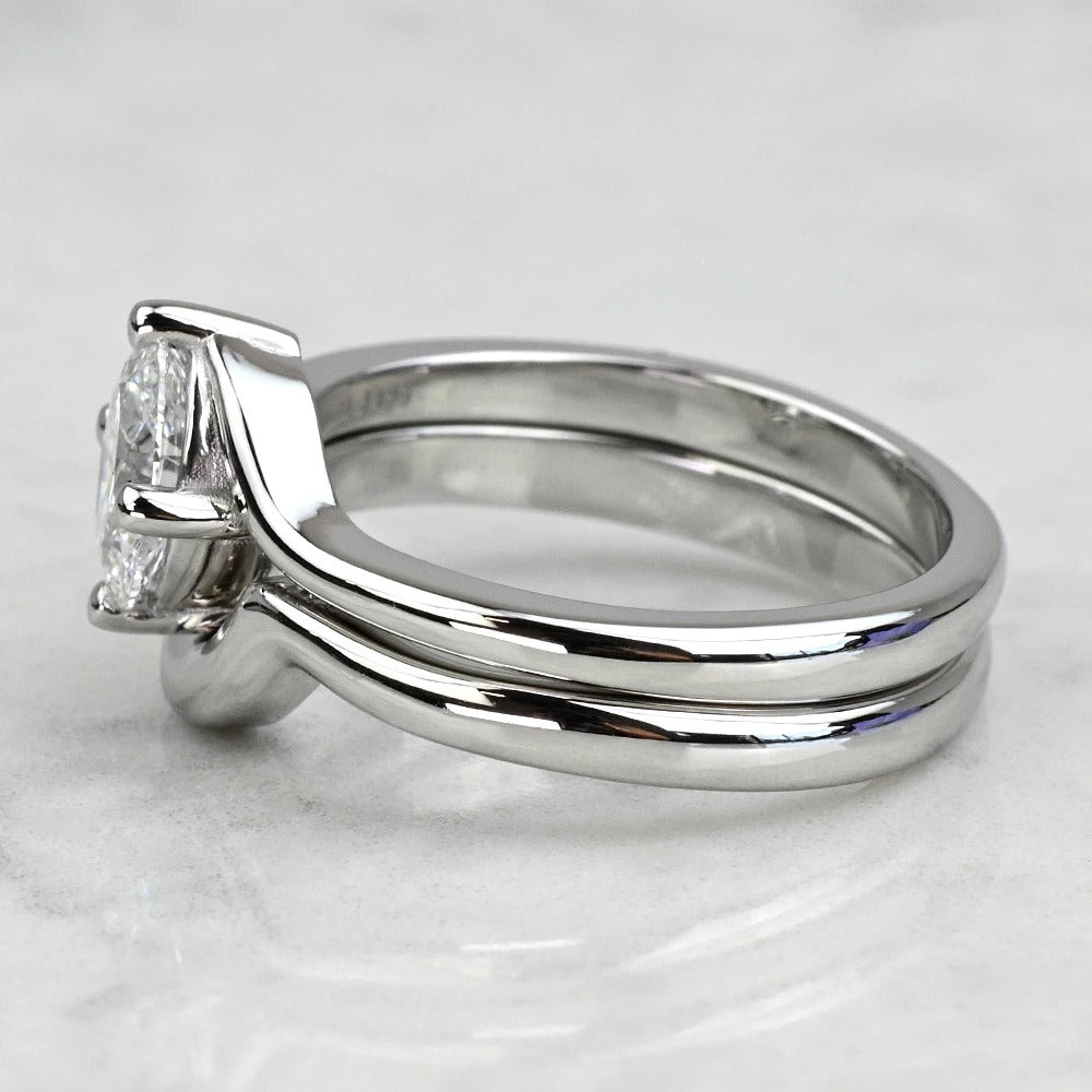 Silver ring with a diamond on a light gray background