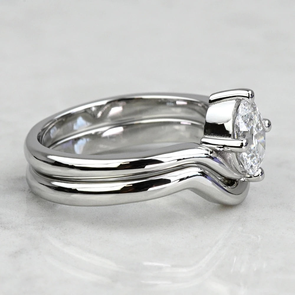 Silver ring with a diamond on a light gray background