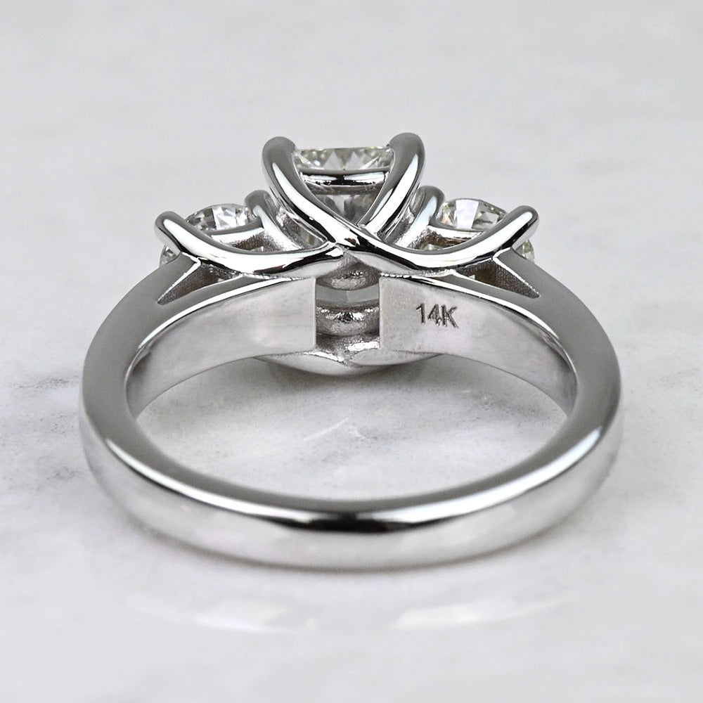 Silver ring with diamond accents on a light gray background