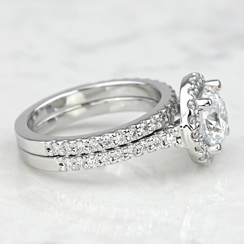 Diamond ring with a matching band on a light gray background