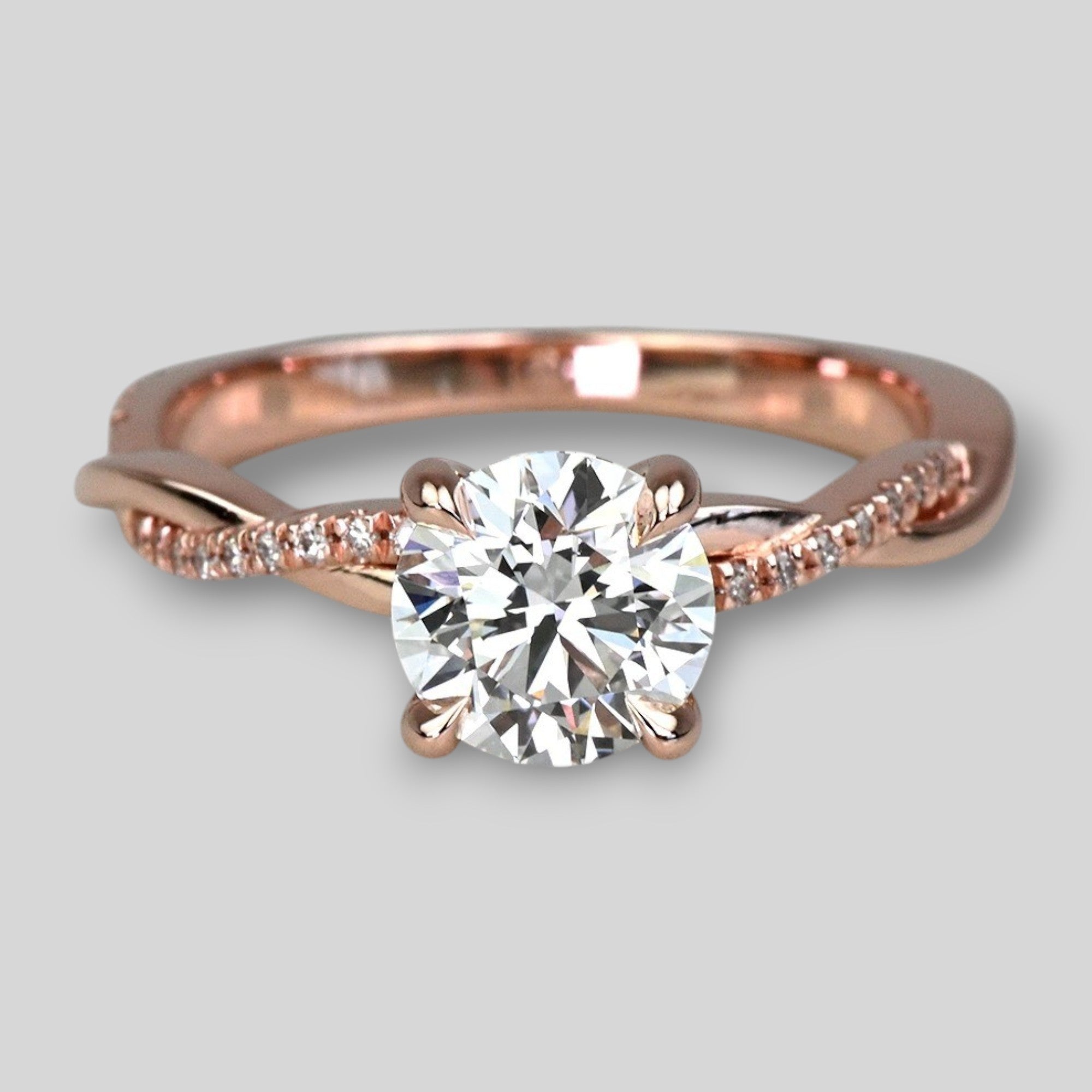 Rose gold ring with a diamond on a light gray background
