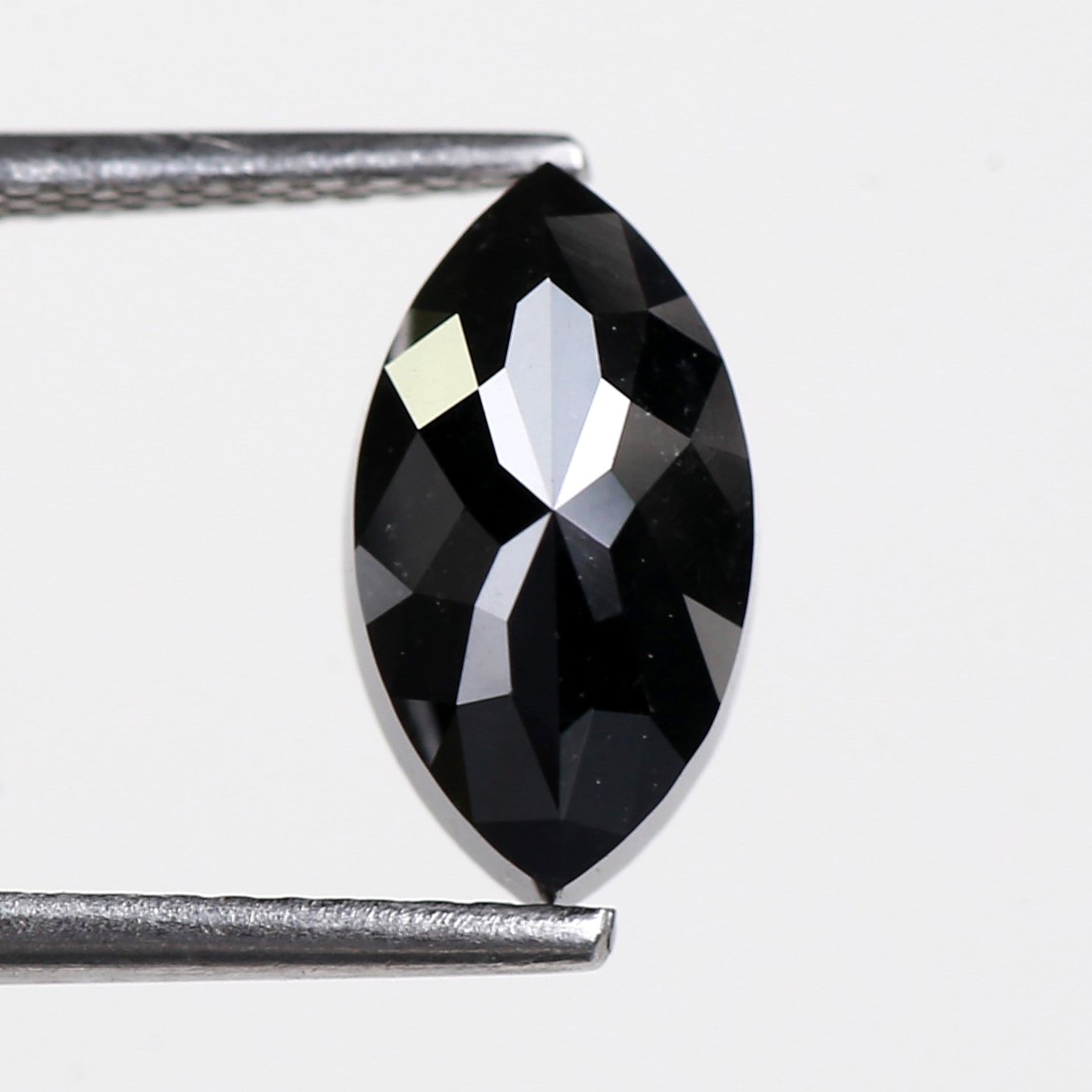 Faceted marquise black diamond on a white background