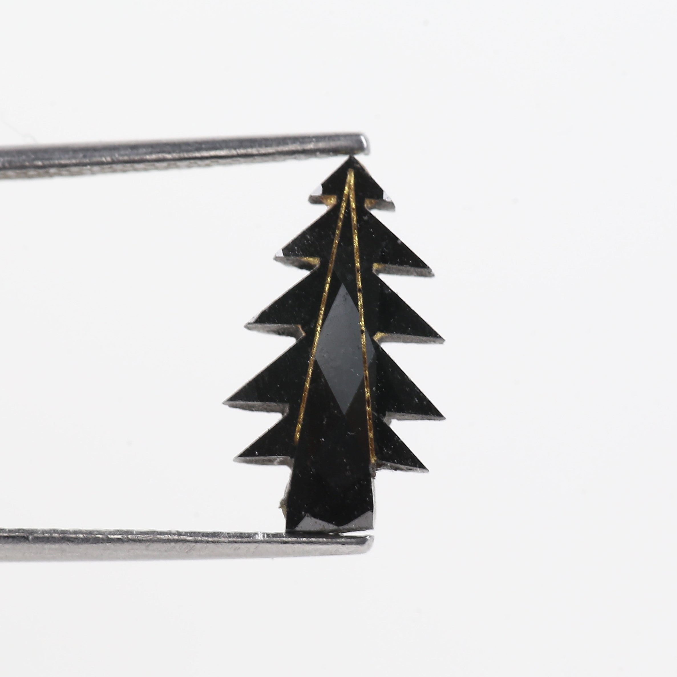 Black tree-shaped hairpin on a white background
