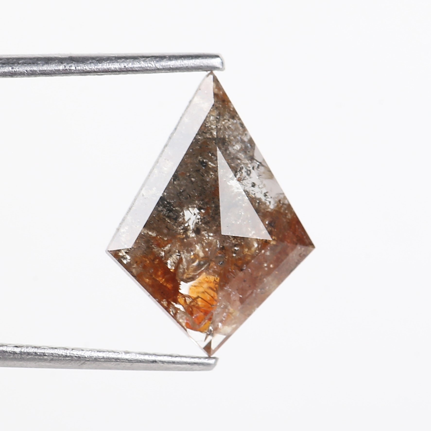 KITE SHAPE crystal held by tweezers on a white background