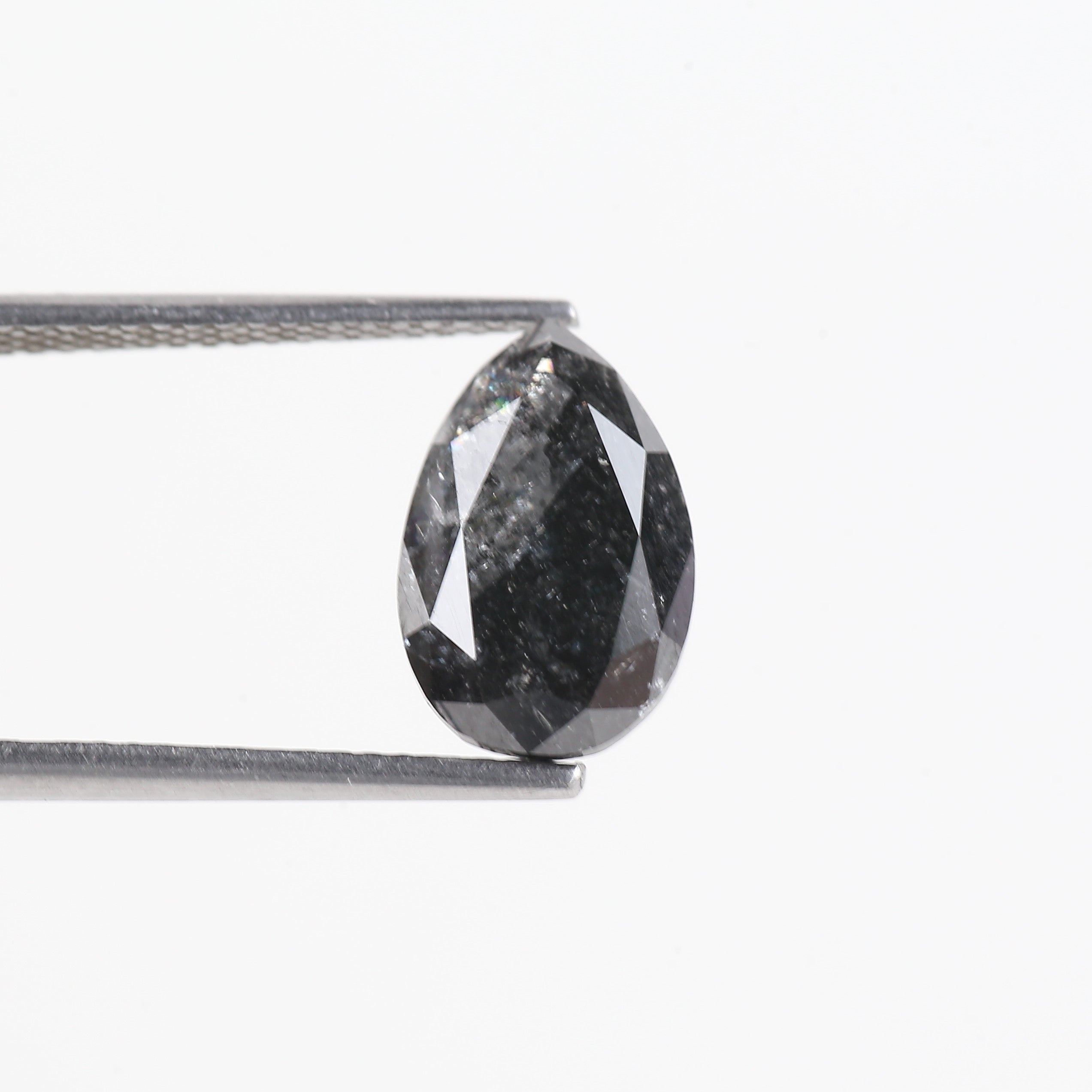 Faceted black diamond on a white background