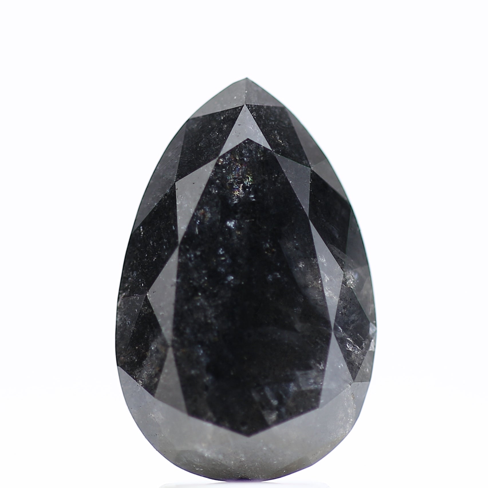 Faceted black gemstone on a white background