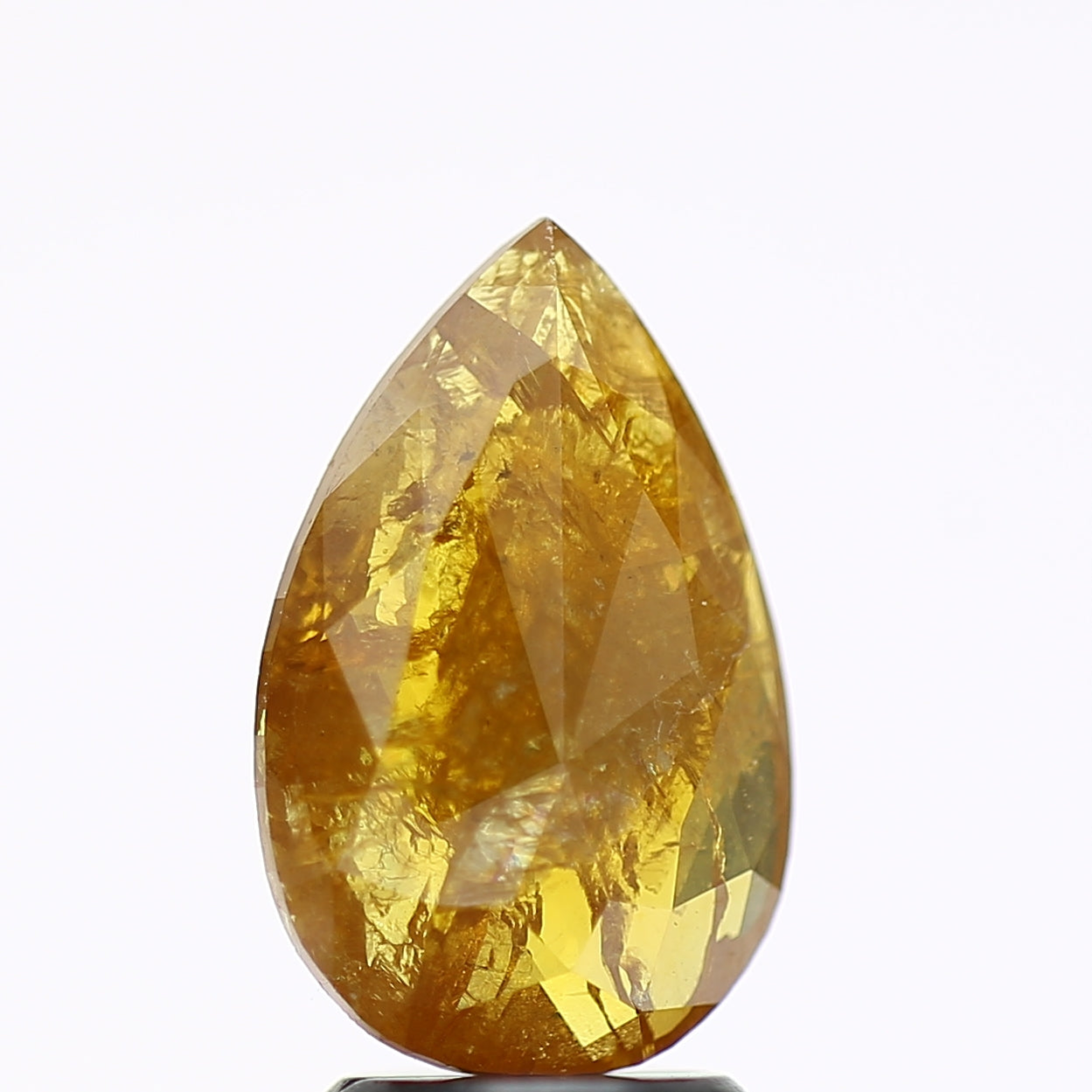 Teardrop-shaped yellow gemstone on a white background