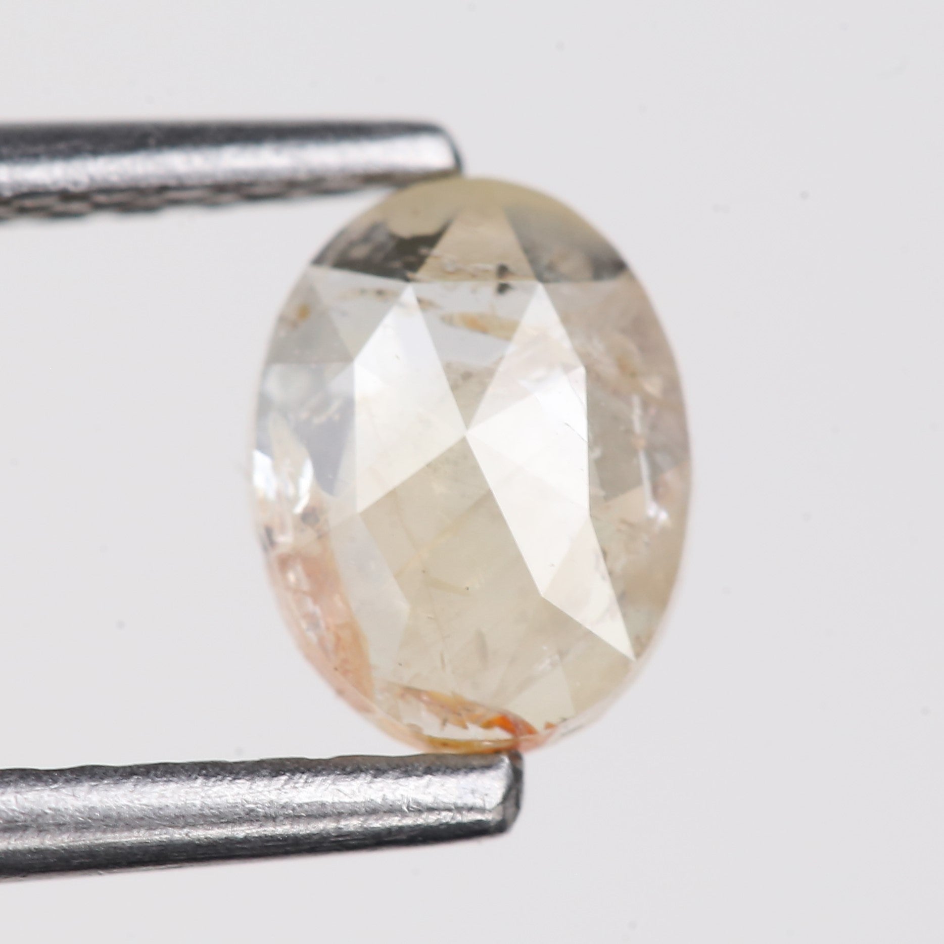 0.48 Carat Natural Light Orange Oval Cut Salt And Pepper Diamond 6.09 MM