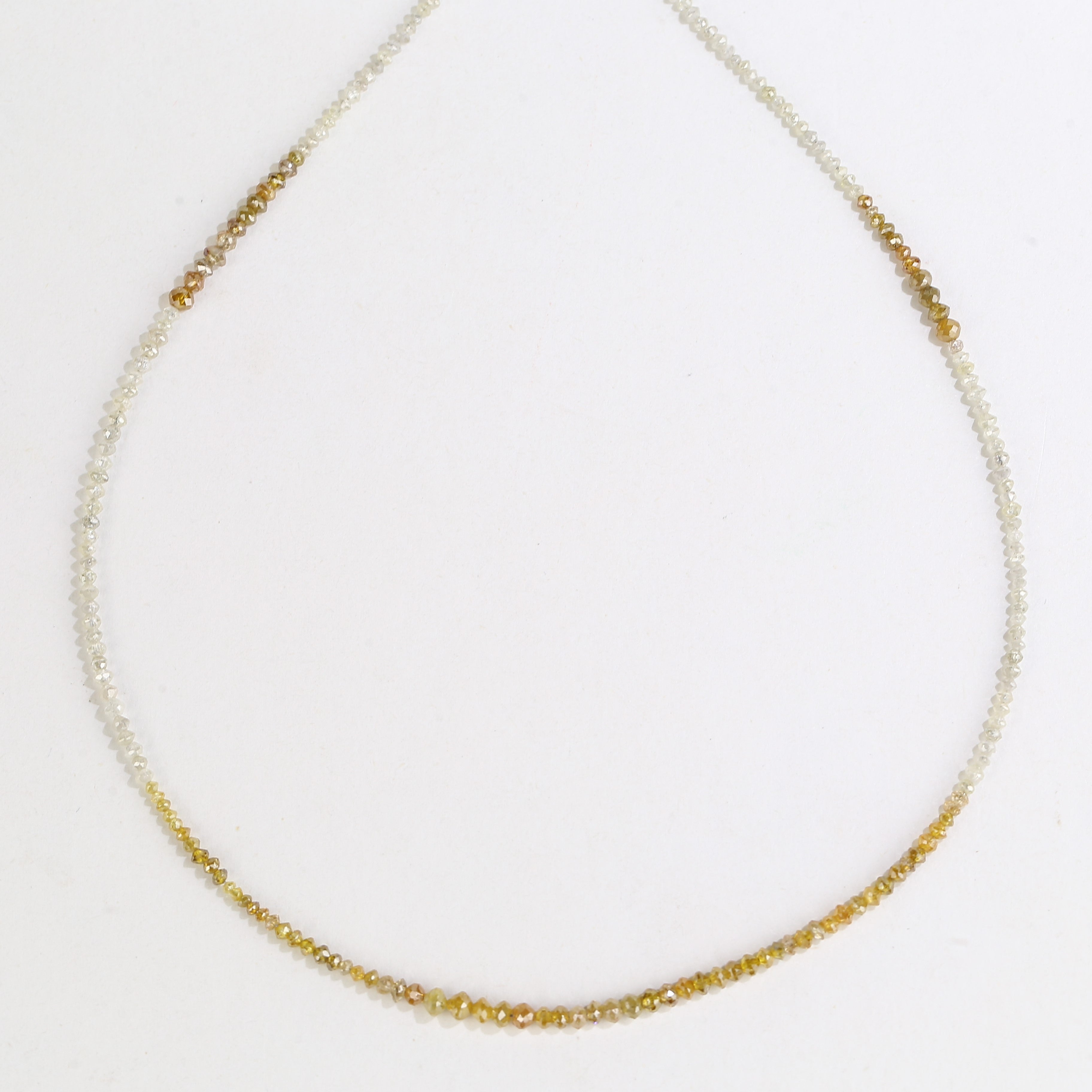 Delicate gold necklace on a white background