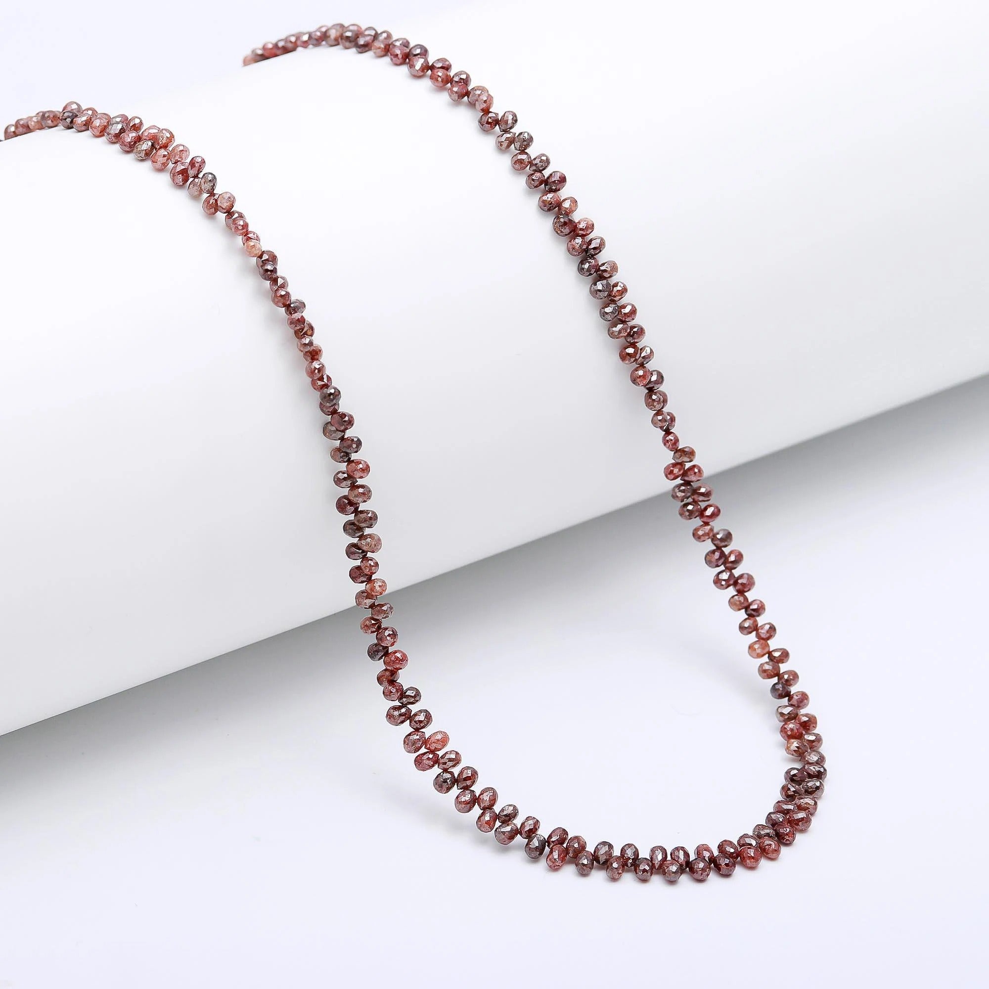 Beaded necklace with red and brown stones on a white background