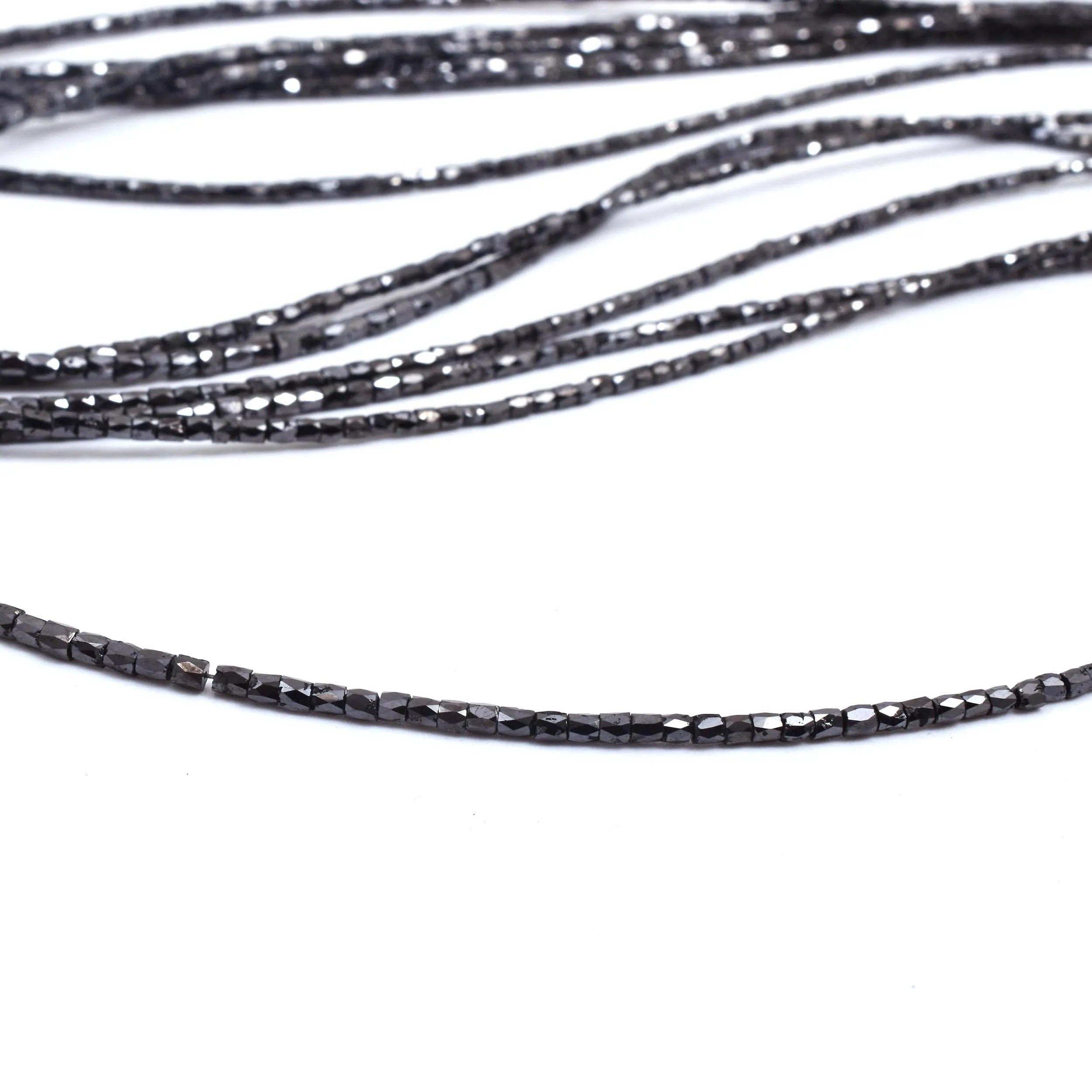 Close-up of black beaded cord on a white background