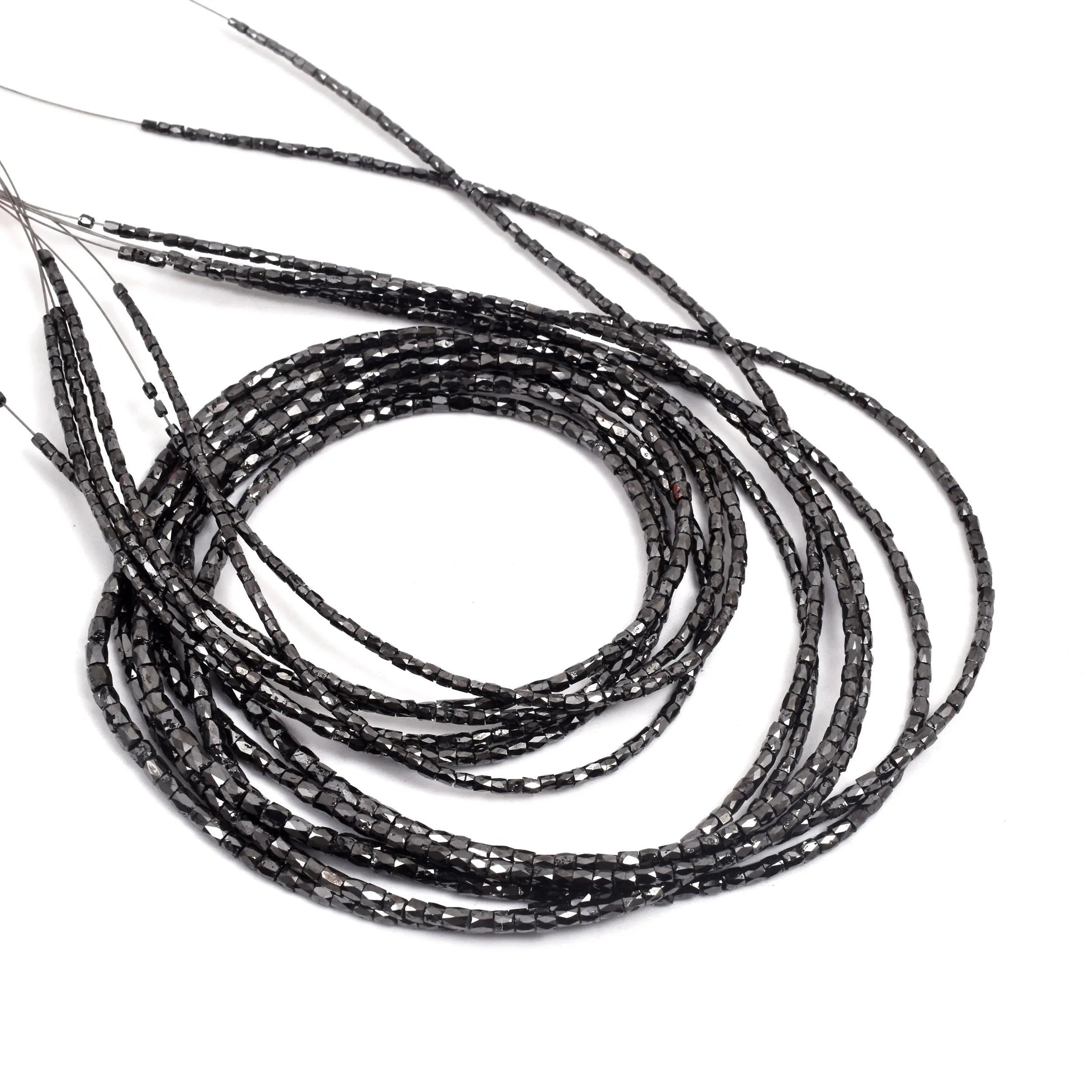 Black beaded strings on a white background
