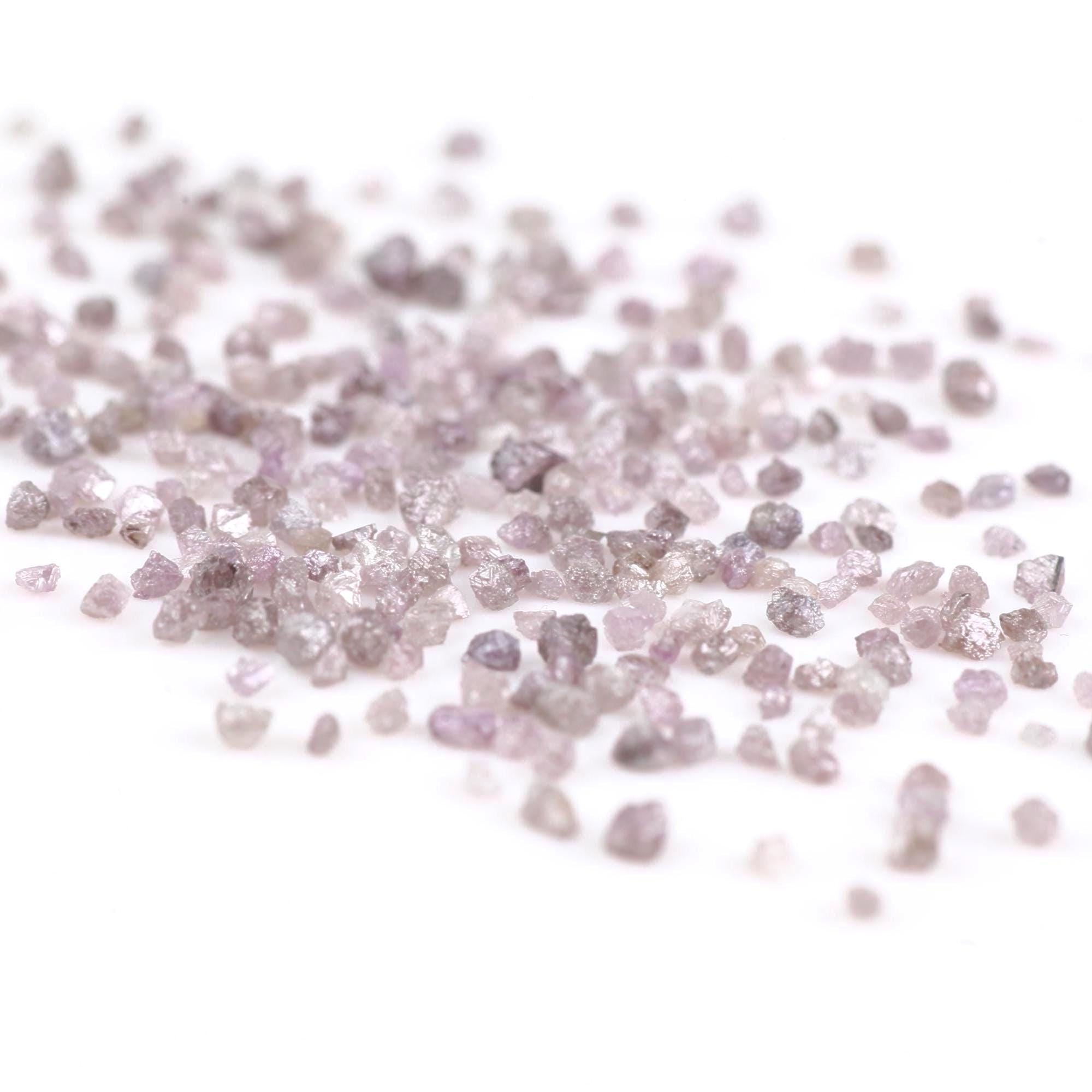 Close-up of small, round, pinkish-purple stones on a white background