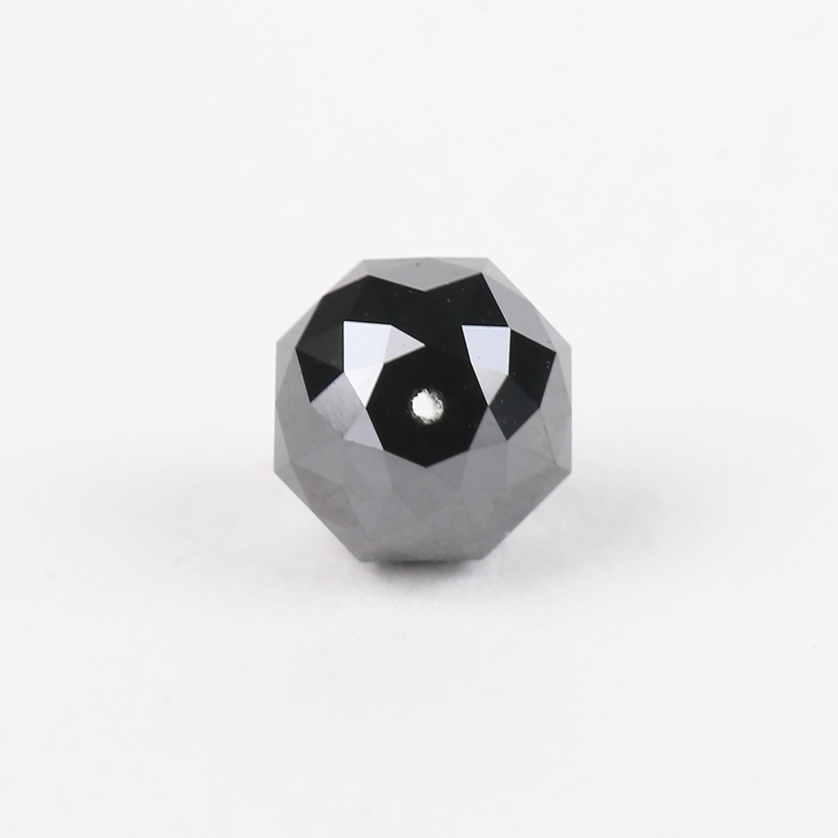 Geometric polyhedron with black and white design on a white background