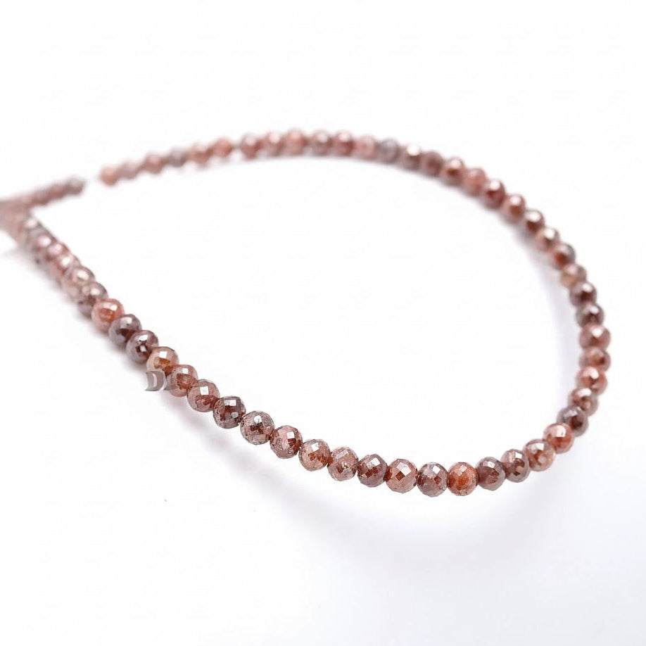 Beaded bracelet with brown and pink stones on a white background