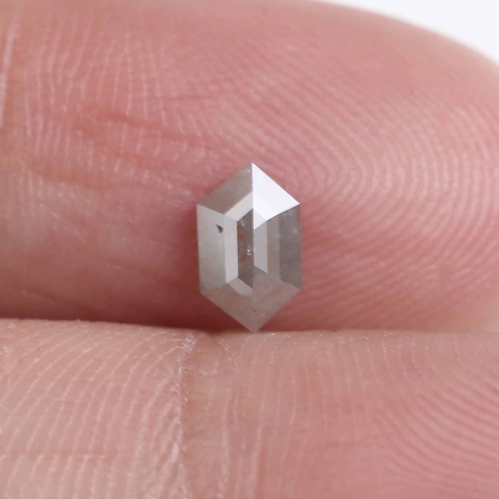 Hexagonal crystal on a person's finger