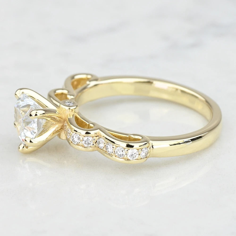 Gold ring with a diamond on a light gray background