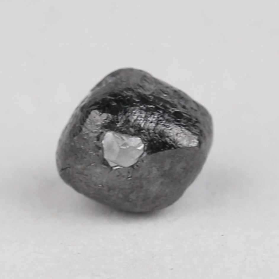 Raw diamond on a light gray background