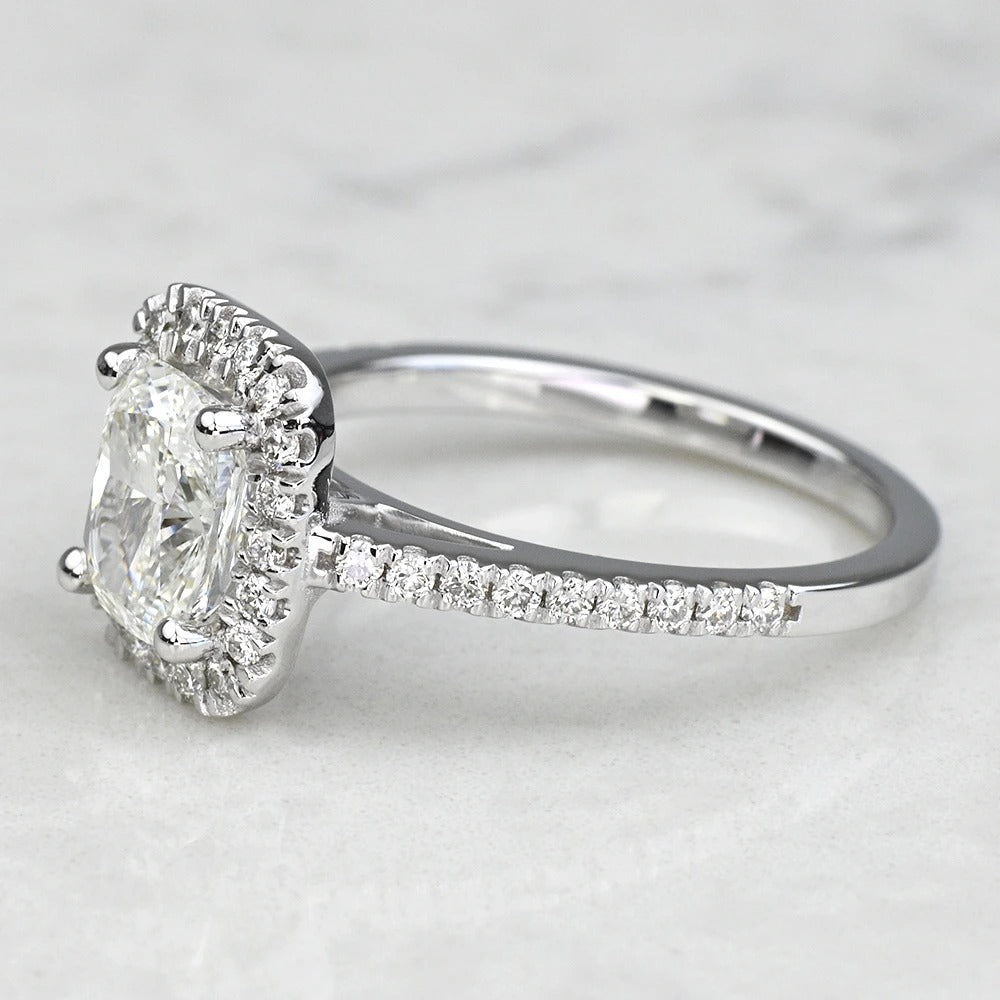 Diamond ring with a clear gemstone on a light gray background