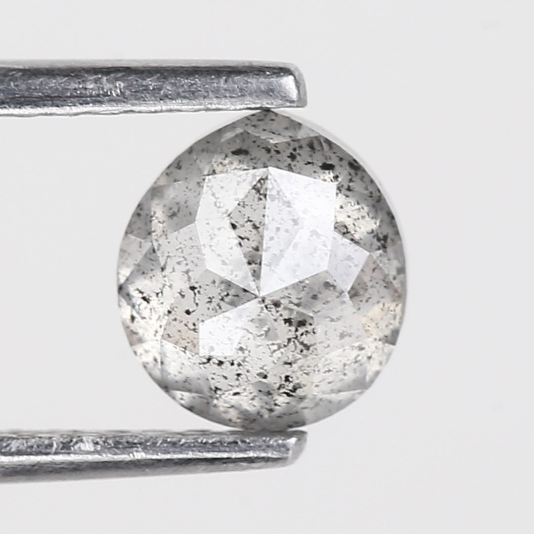 Round diamond held by a silver prong setting on a light gray background