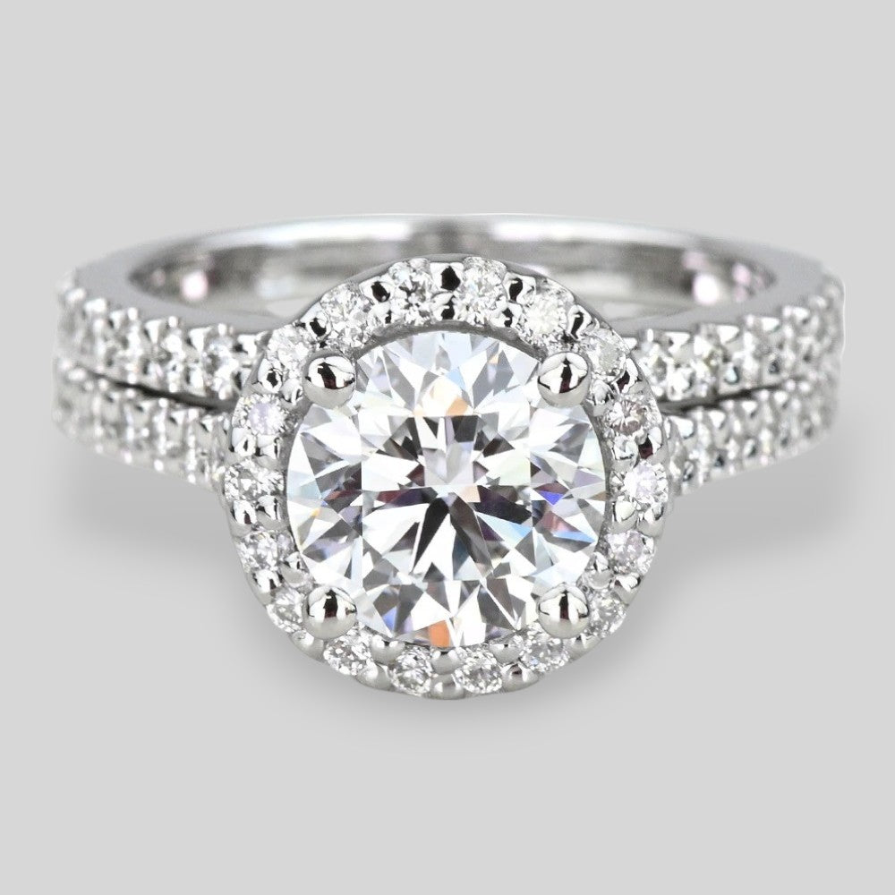 14K White gold ring with a large diamond and smaller diamonds on a gray background