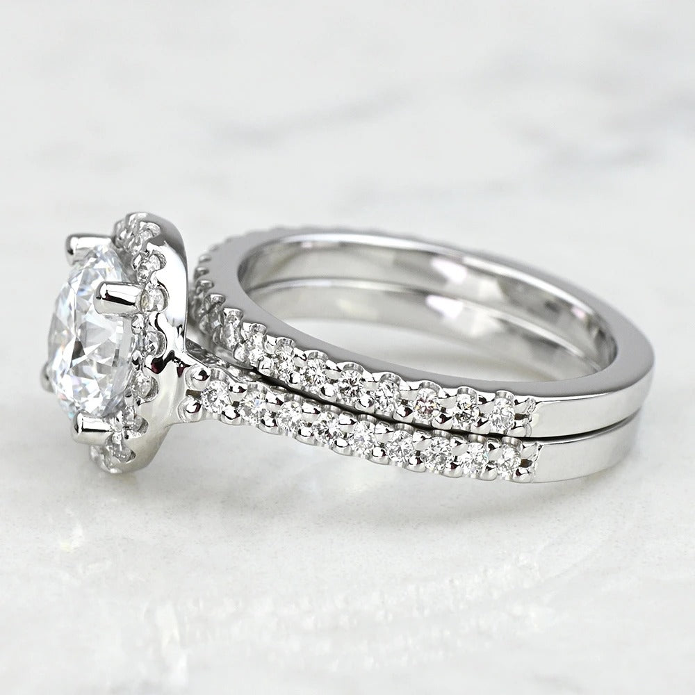 14k white gold ring with a large diamond and smaller diamonds on a white background
