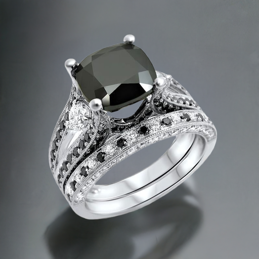 A black cushion cut diamond engagement ring with accent diamonds set in a 14k white gold band, accompanied by a matching wedding band.
