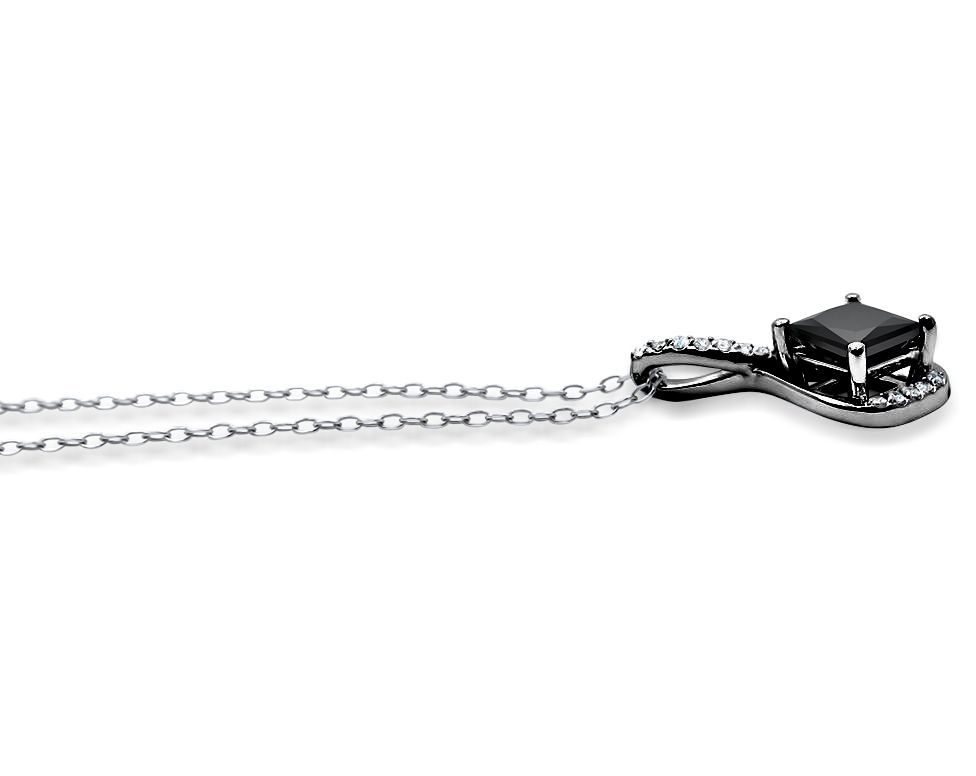 Black diamond pendant on a chain against a white background