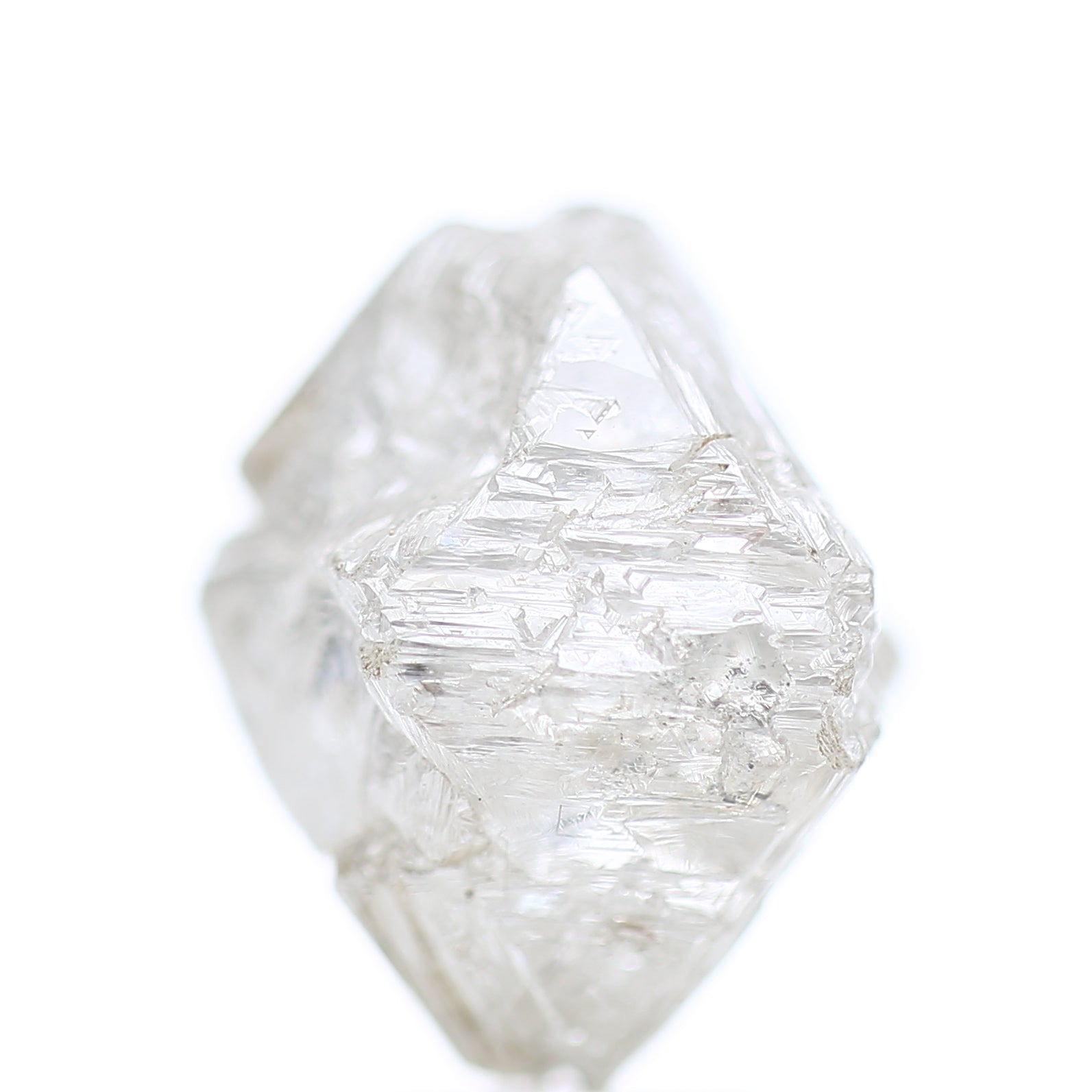 Clear White rough diamond octahedron shape on a white background
