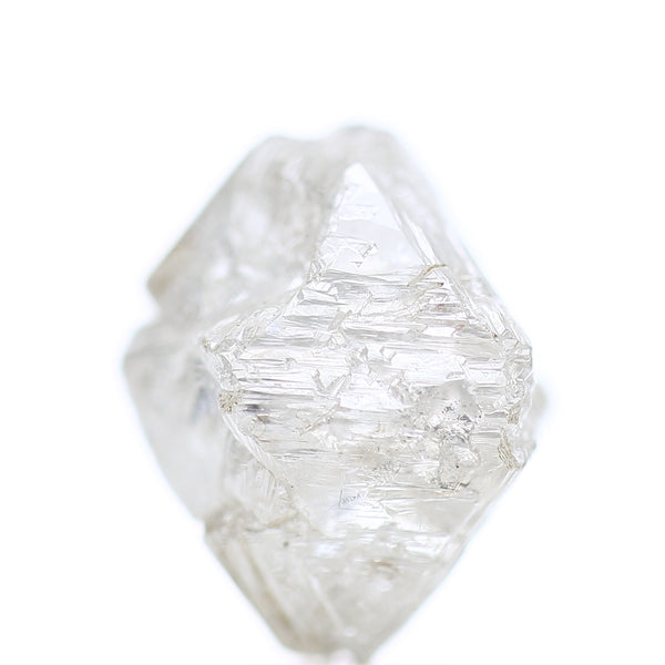 Clear White rough diamond octahedron shape on a white background