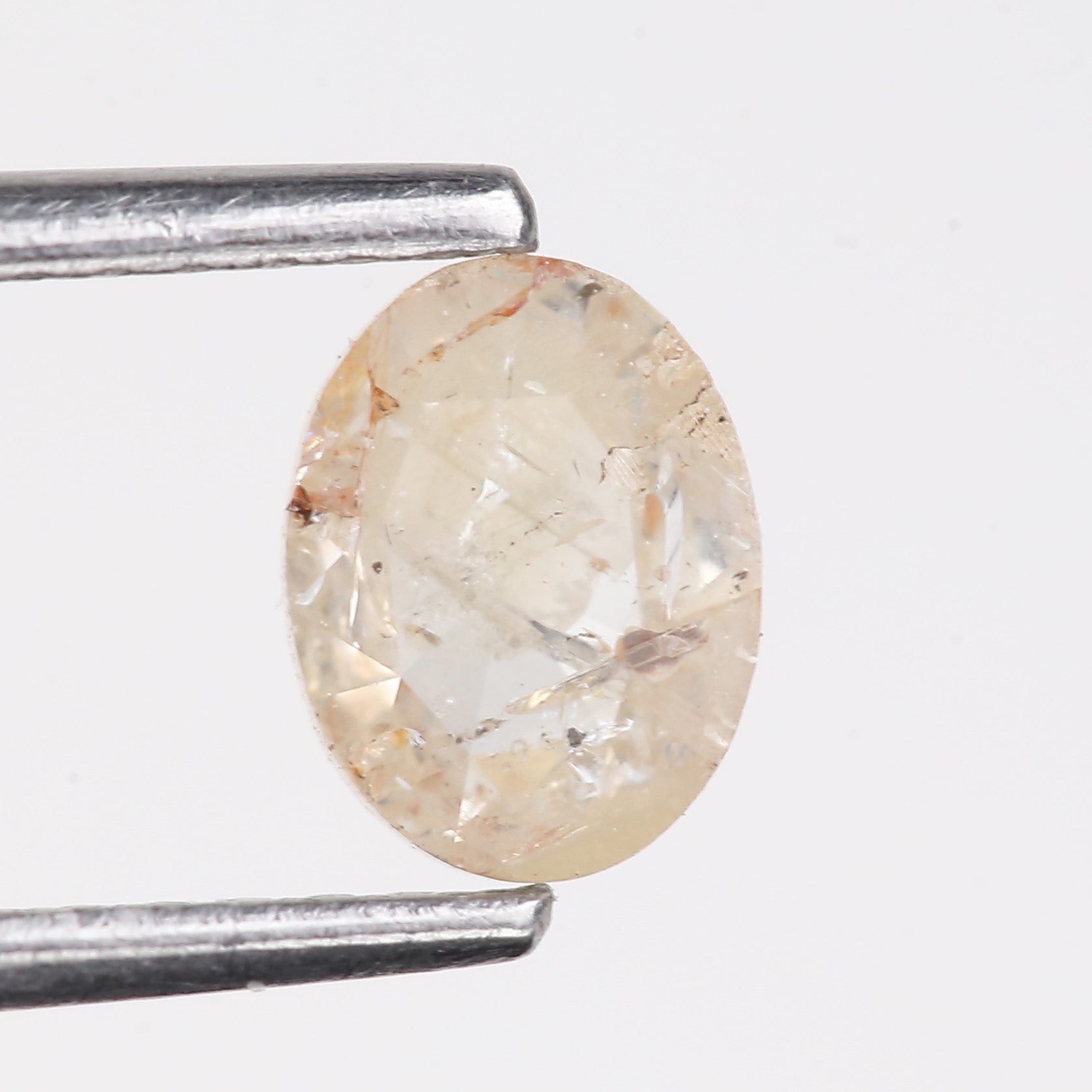 0.48 Carat Natural Light Orange Oval Cut Salt And Pepper Diamond 6.09 MM