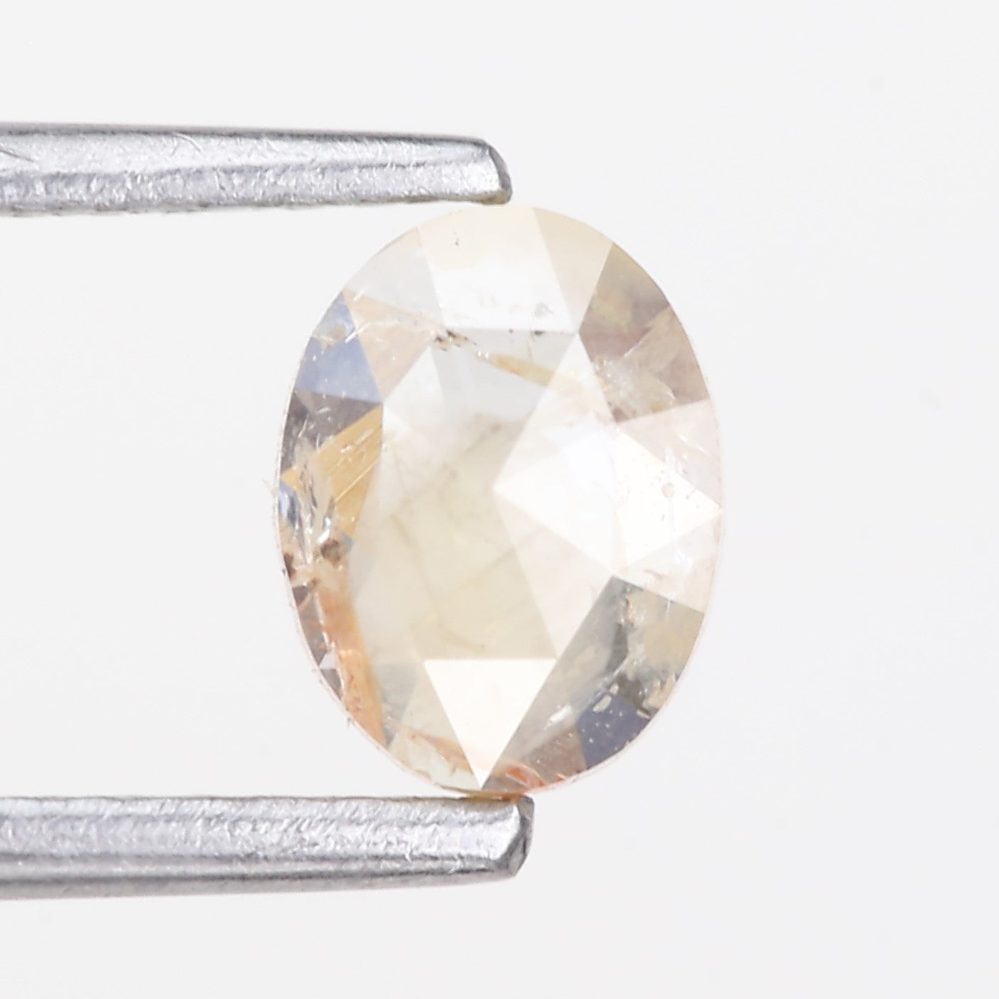 0.48 Carat Natural Light Orange Oval Cut Salt And Pepper Diamond 6.09 MM