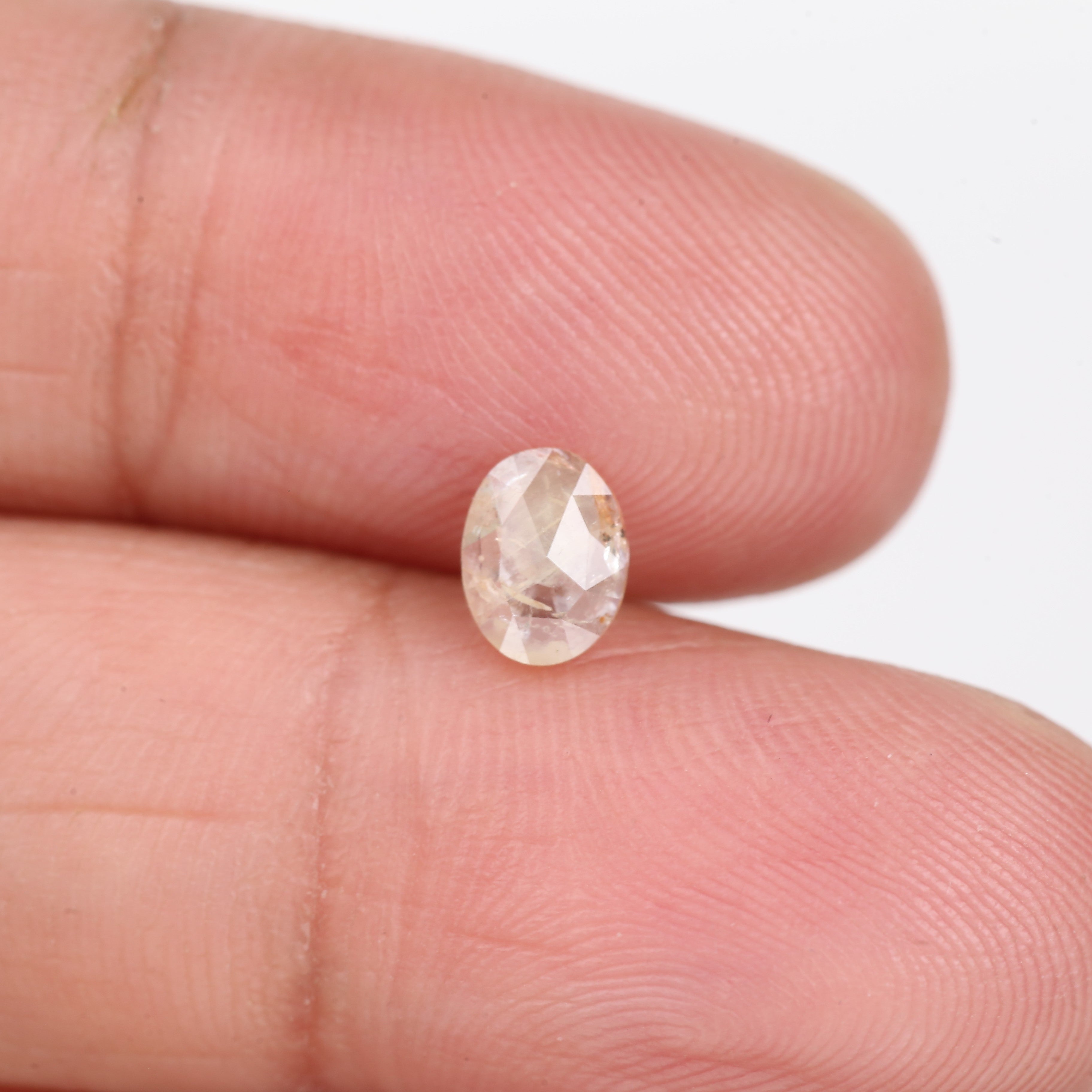 0.48 Carat Natural Light Orange Oval Cut Salt And Pepper Diamond 6.09 MM