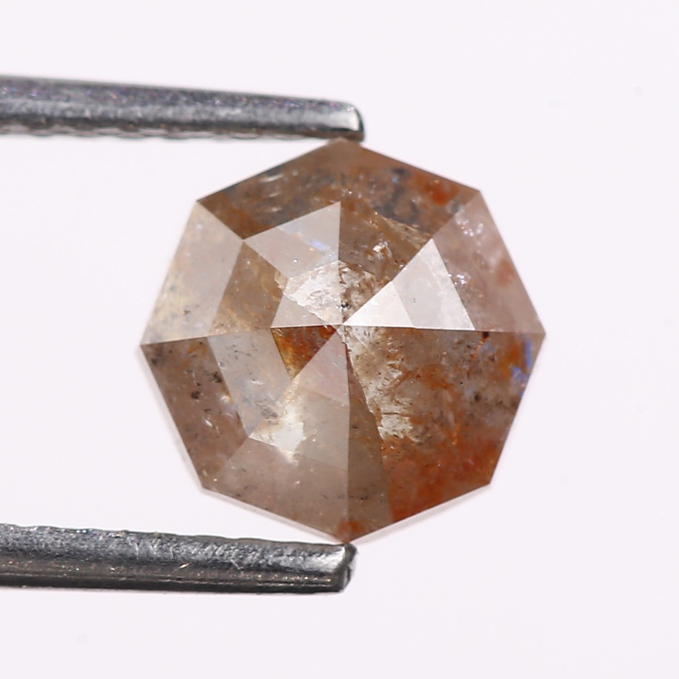 Faceted diamo with a hexagonal shape on a white backgroundd
