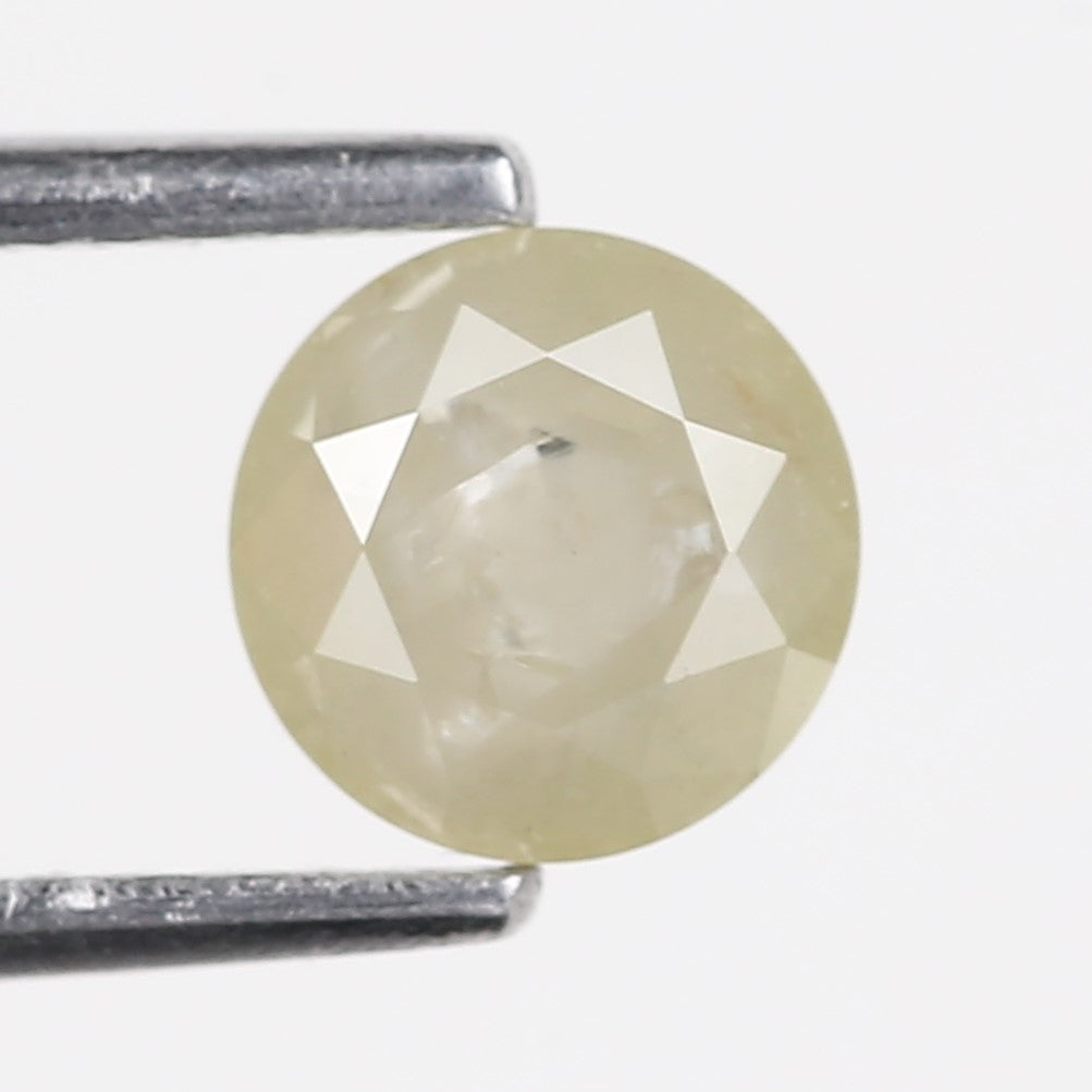 Round cut diamond held by tweezers on a white background