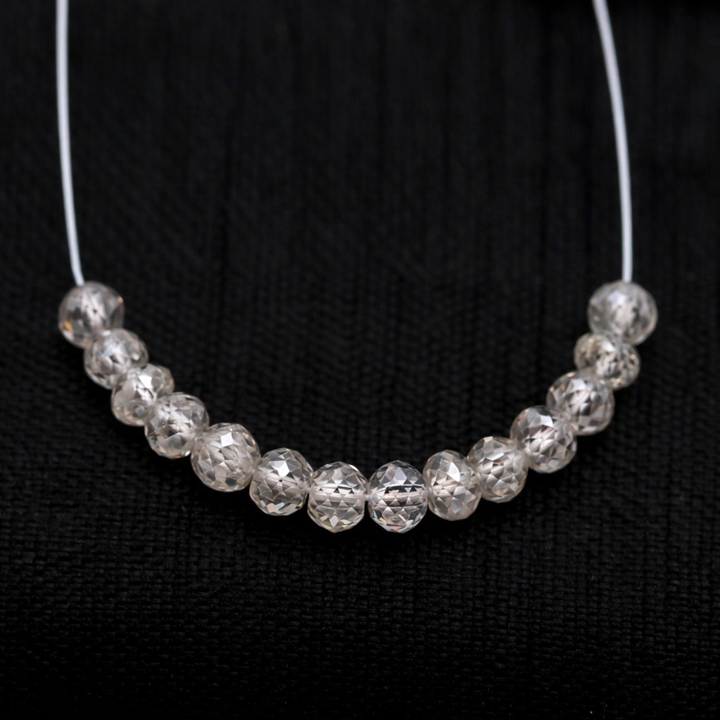 Silver white beaded necklace on a black background