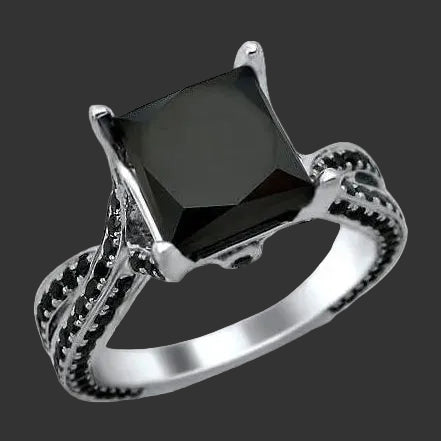 14k white gold ring with a princess black diamond on a white background