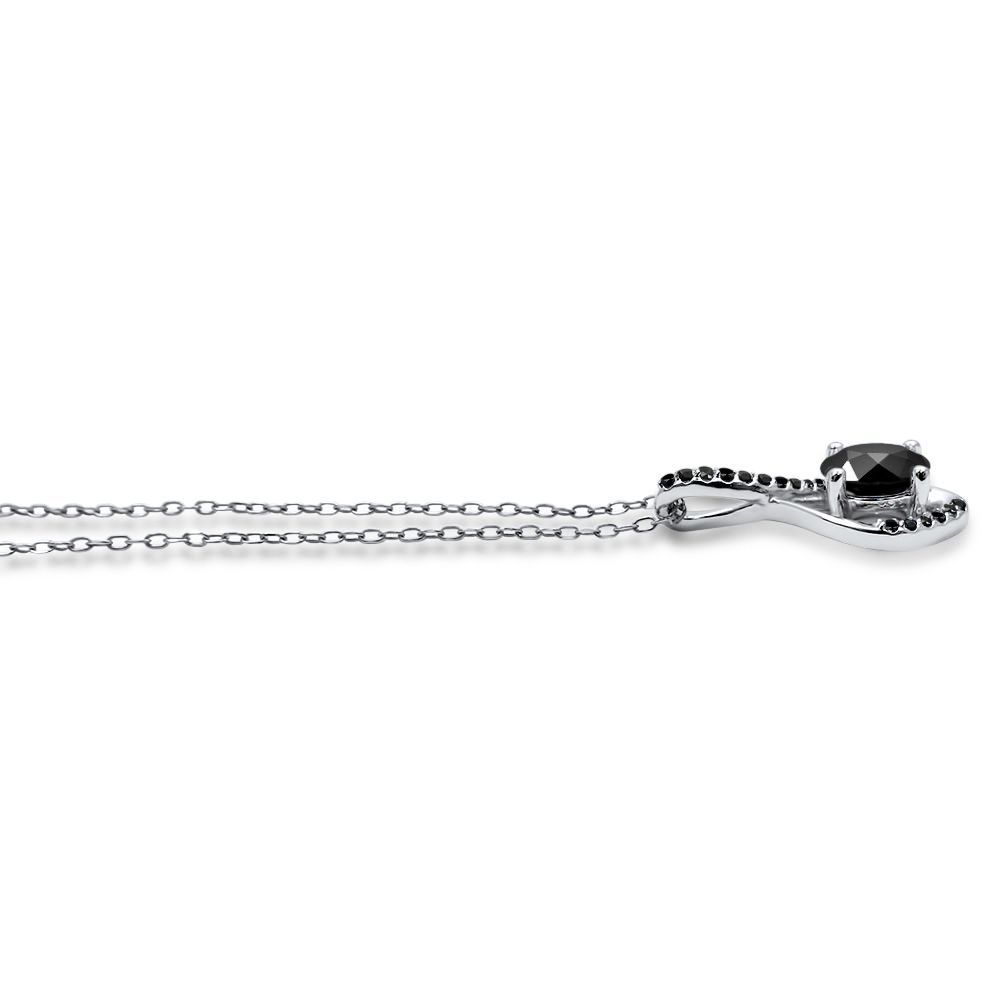 Silver necklace with a black gemstone on a white background