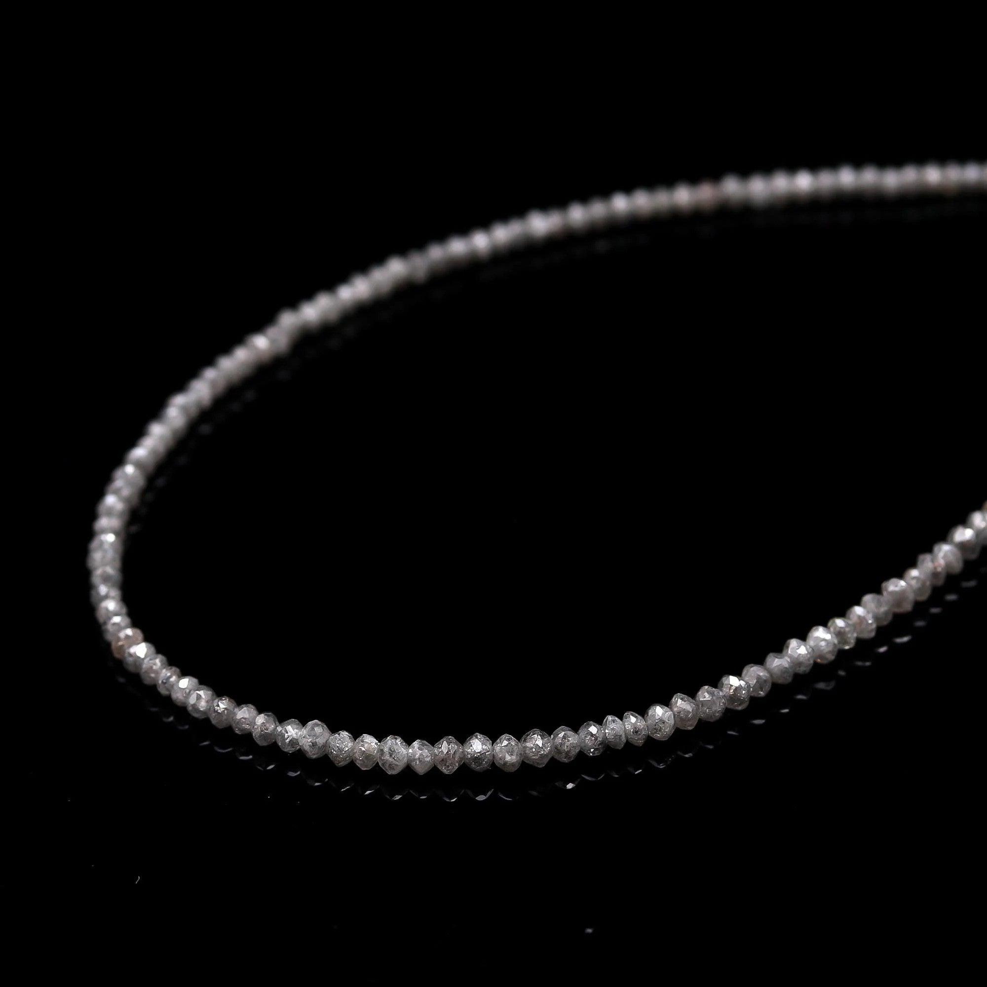 Thin silver chain on a black background