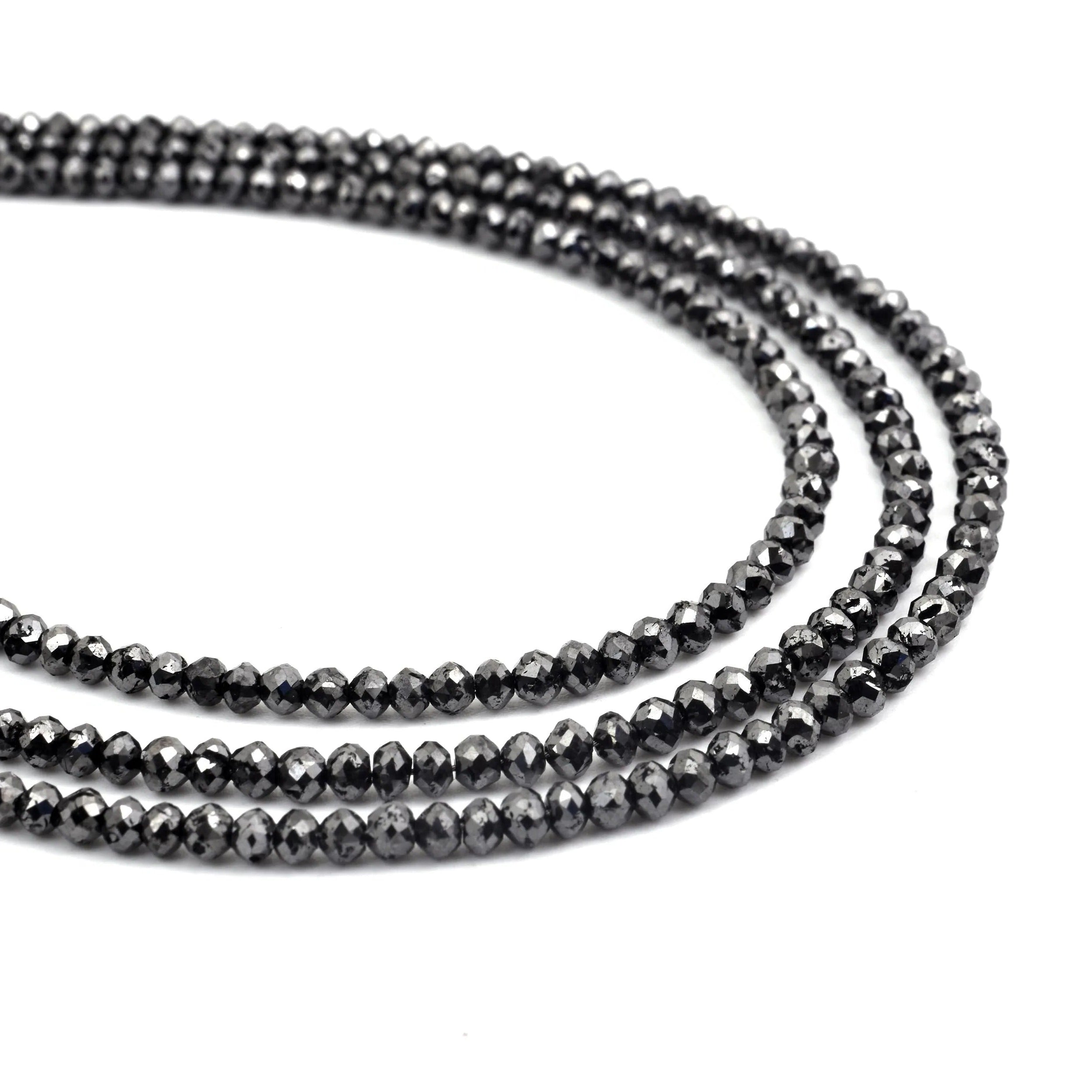 Two strands of black beaded jewelry on a white background