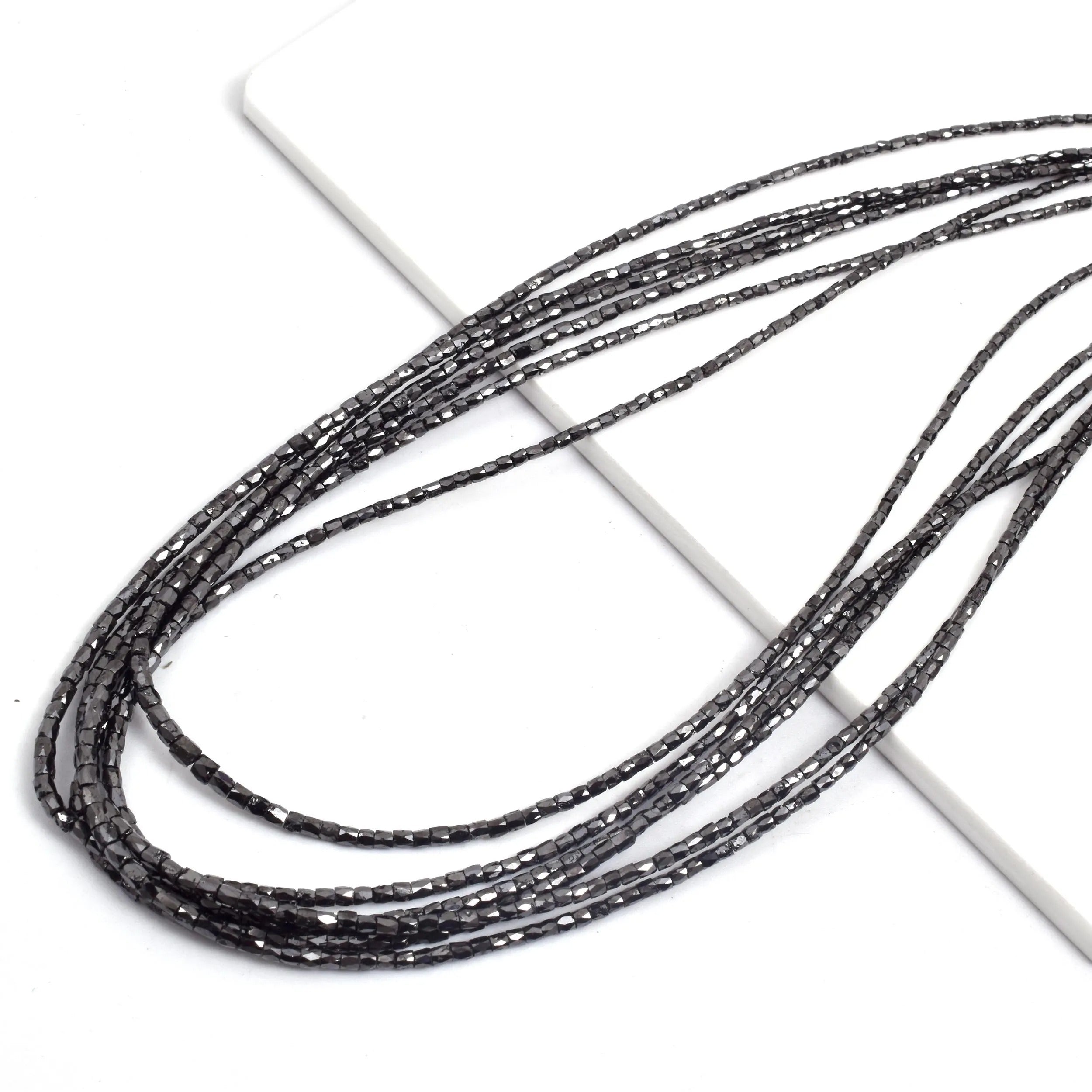 Black beaded string on a white background